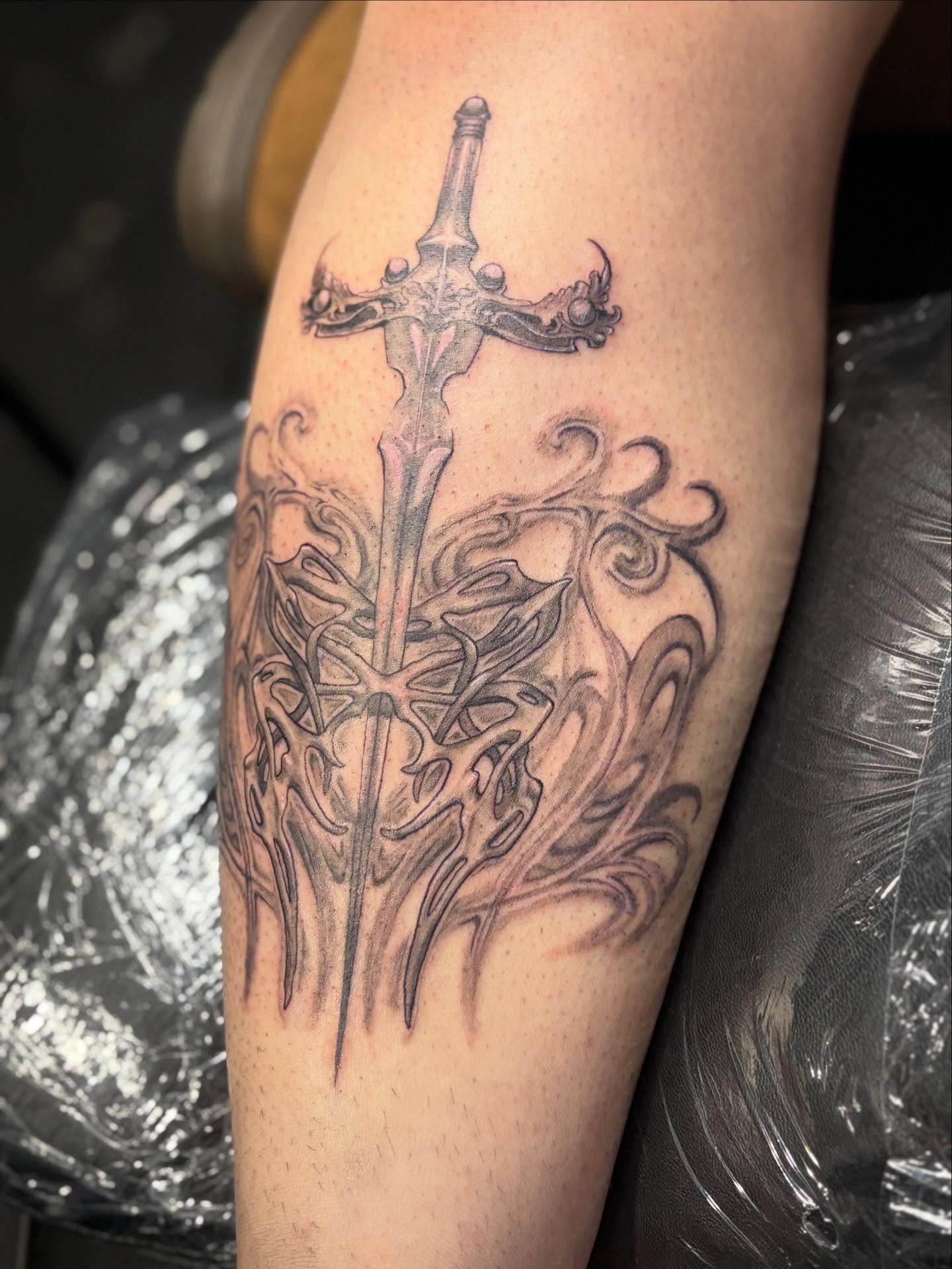 Sword and flames geometric tattoo on the forearm by Slade Nowicki