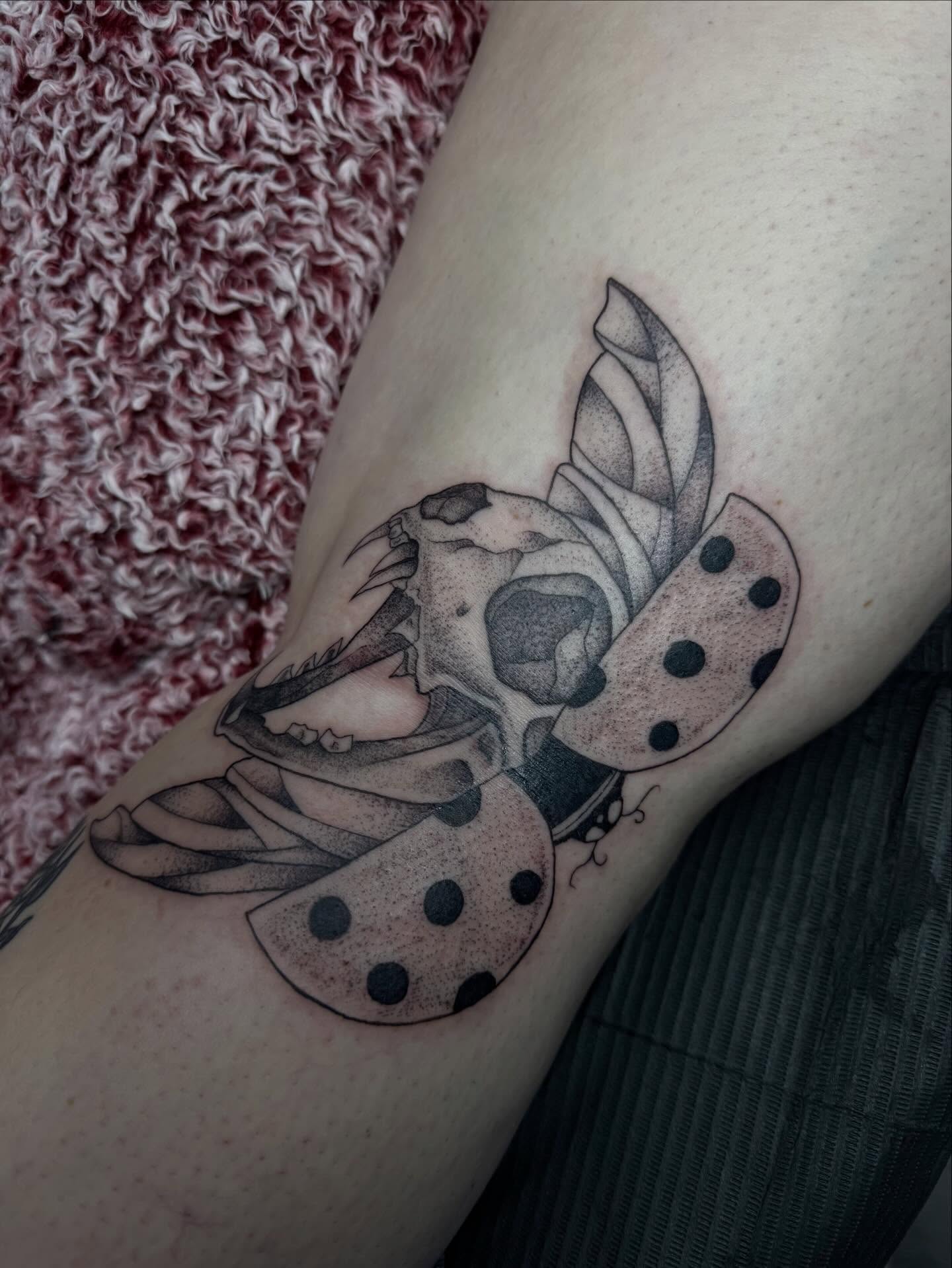 Skull with polka dots dotwork tattoo on the forearm by olivia reed