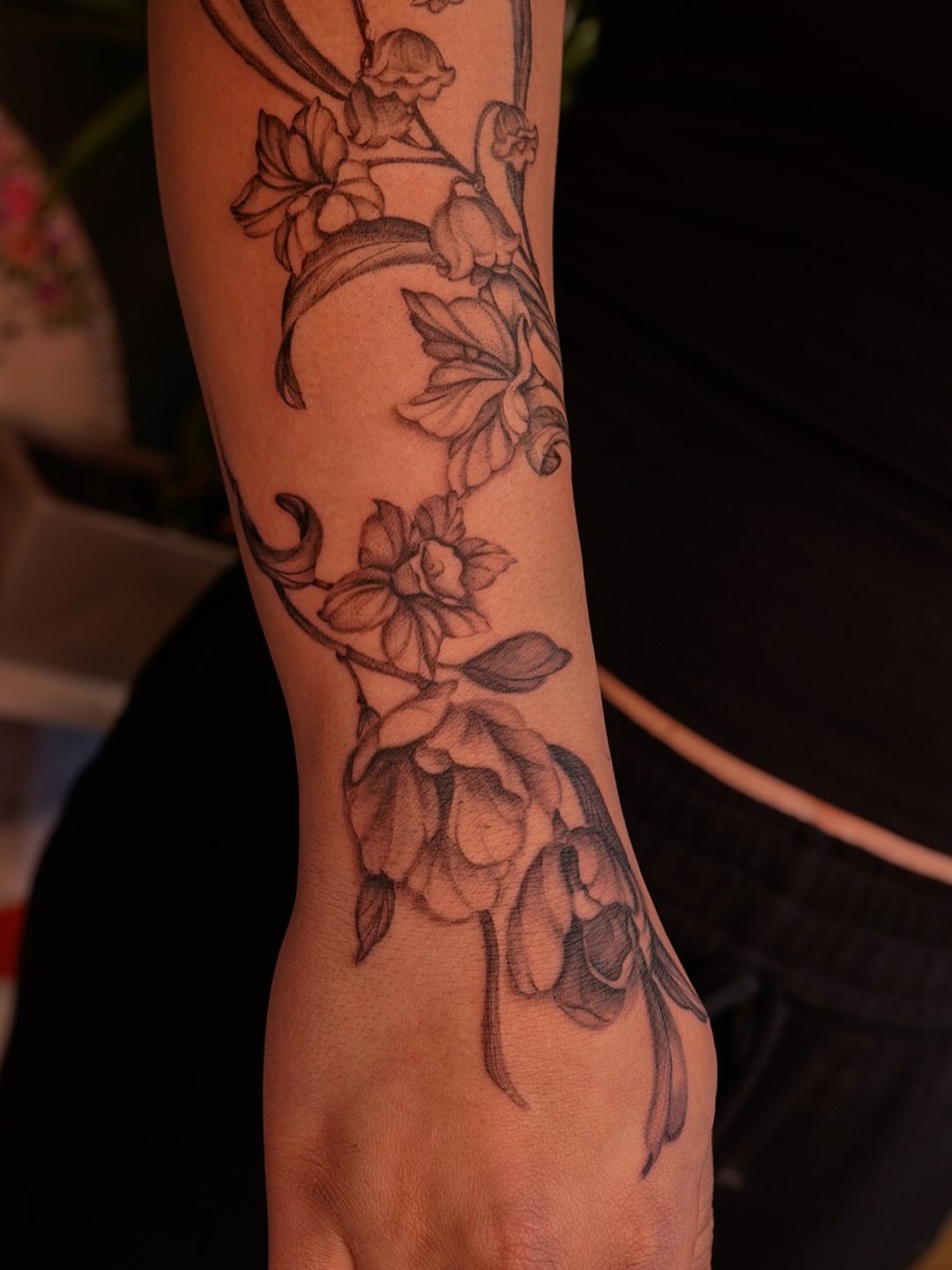 Floral vine black and grey tattoo on the forearm by Nicki Yến