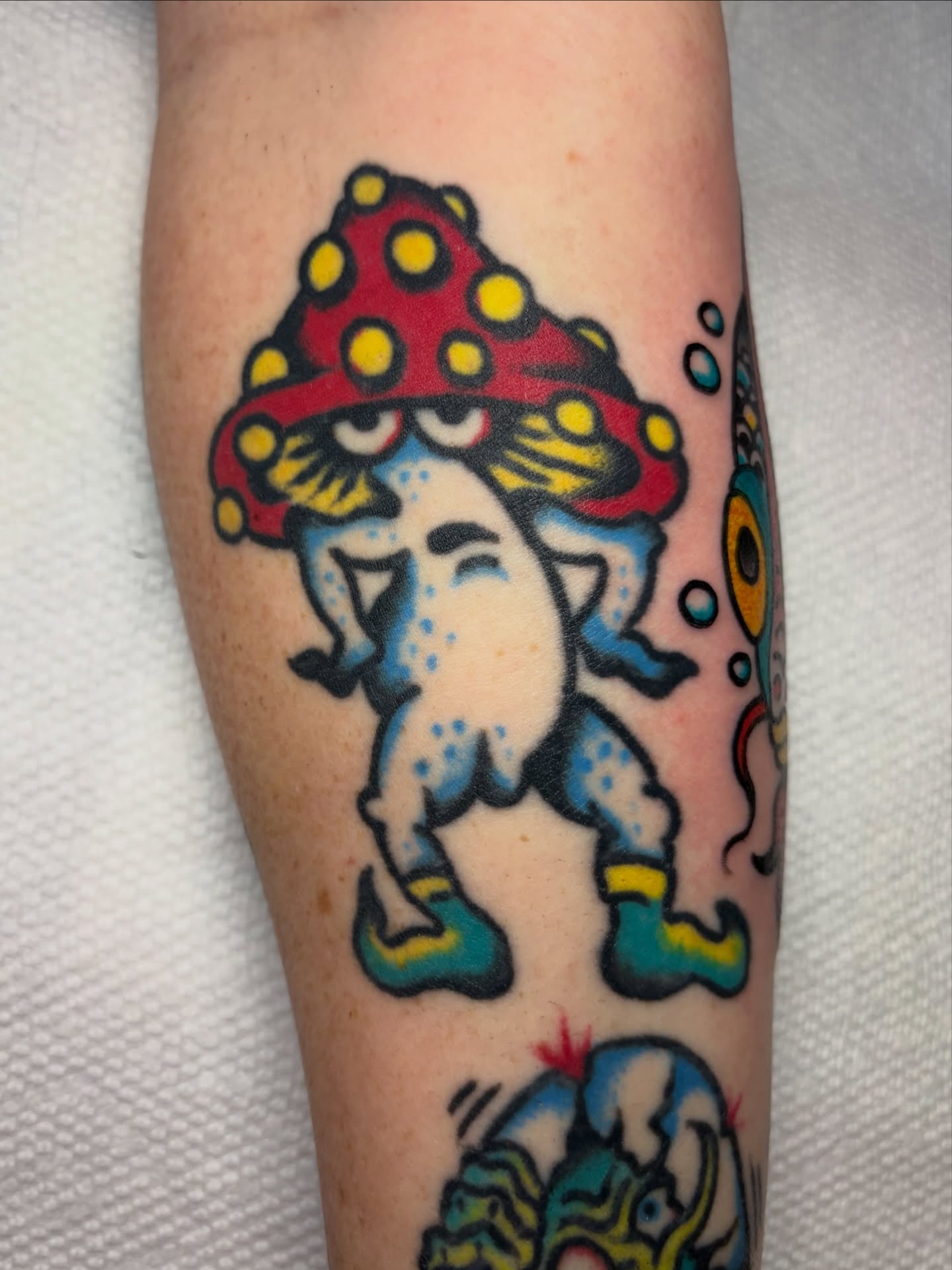 Mushroom character American traditional tattoo on the forearm by David Armacost, Cincinnati, Ohio
