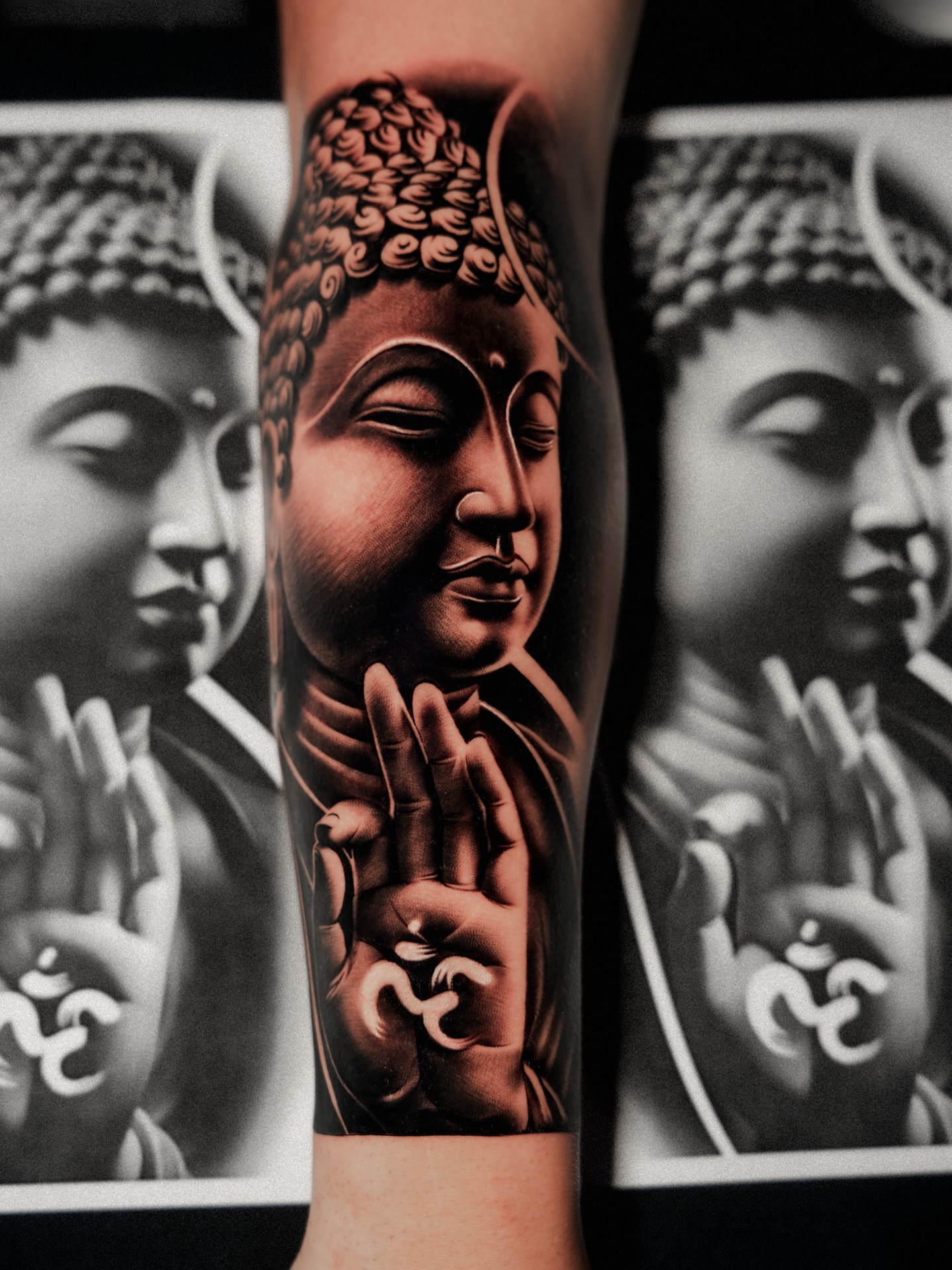 Buddha head realism tattoo on the forearm by Andy Garcia
