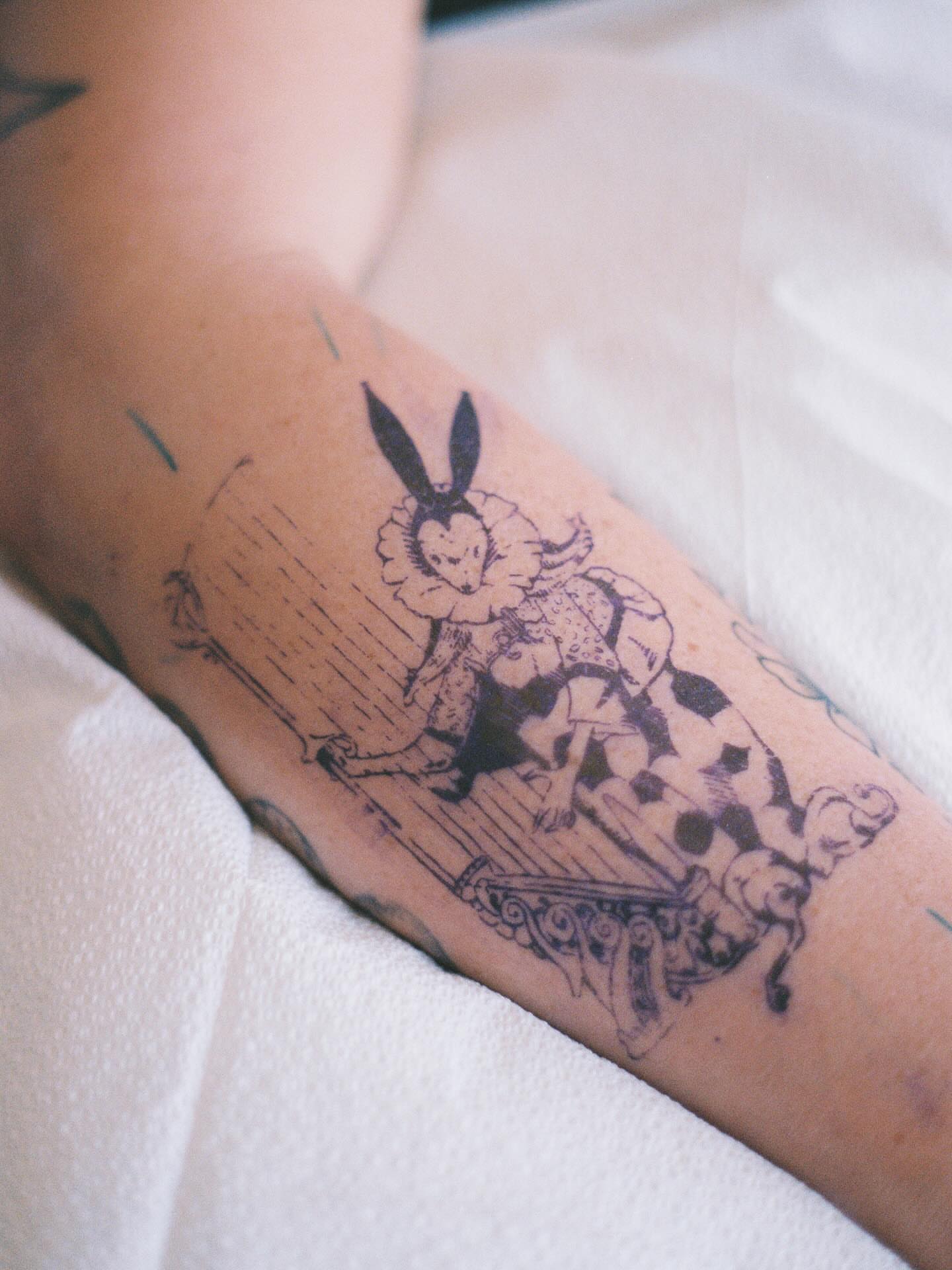 Rabbit black and grey tattoo on the forearm by Maddie Hammell