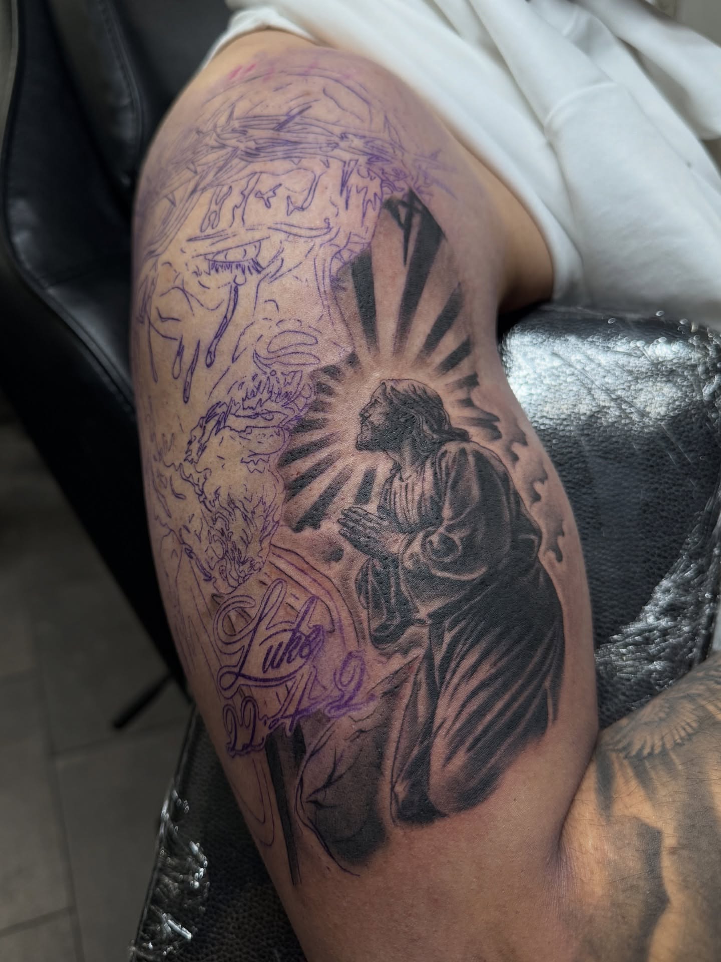 Religious figure realism tattoo on the upper arm by Eduardo Chaparro
