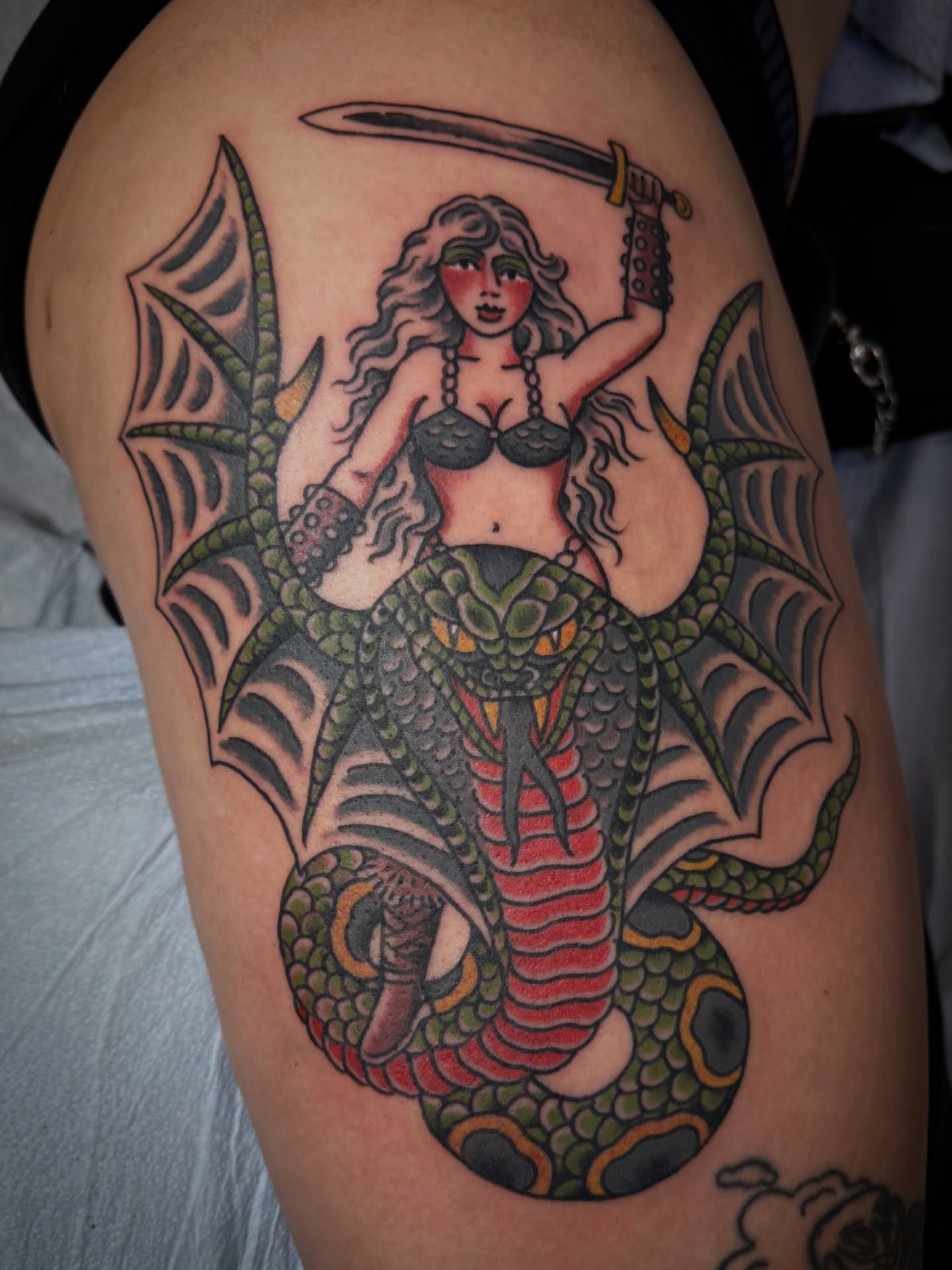 Mermaid with sword American traditional tattoo on the thigh by Jesse Swanson, Santa Rosa, California