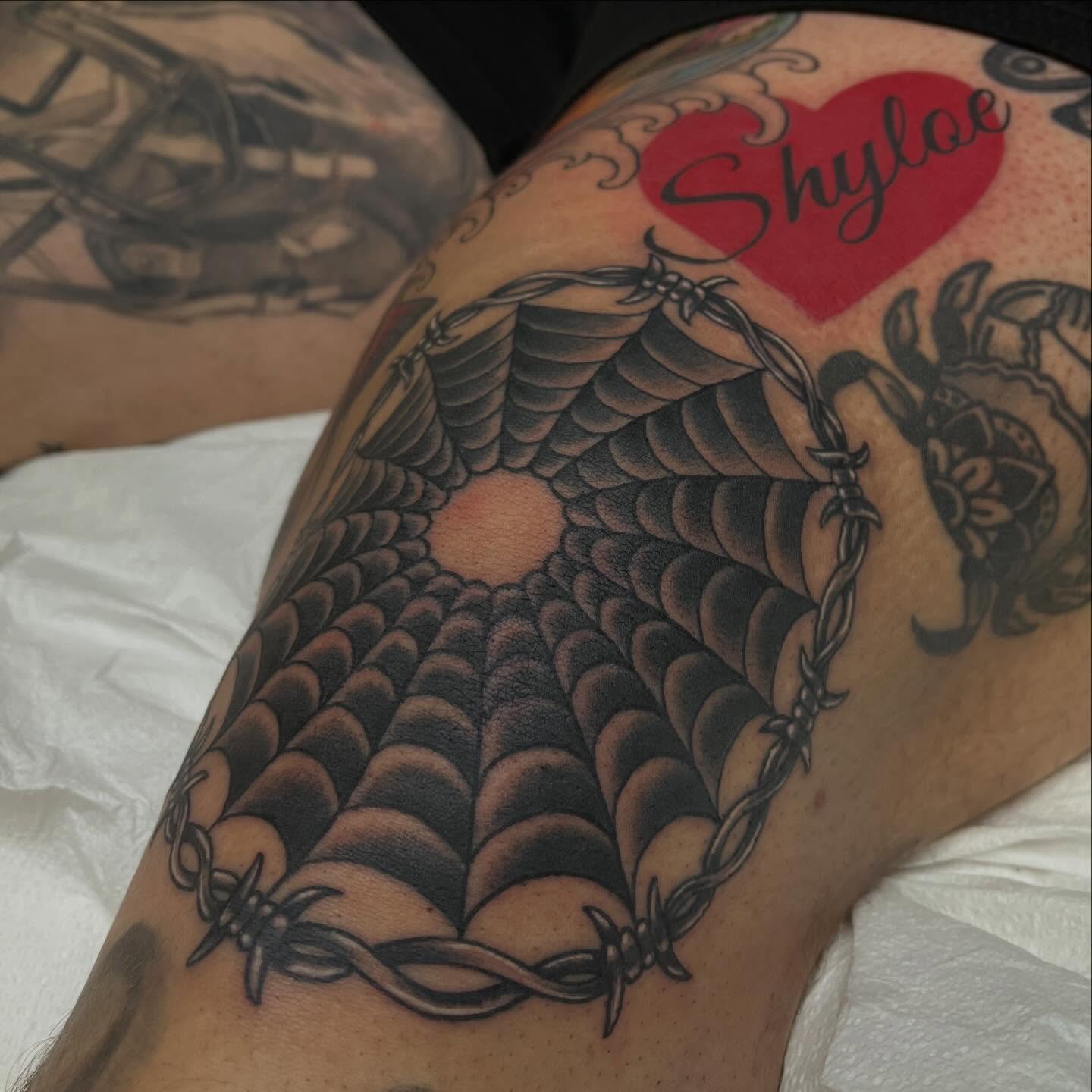 Snake black and grey tattoo on the thigh by Adam Habecker