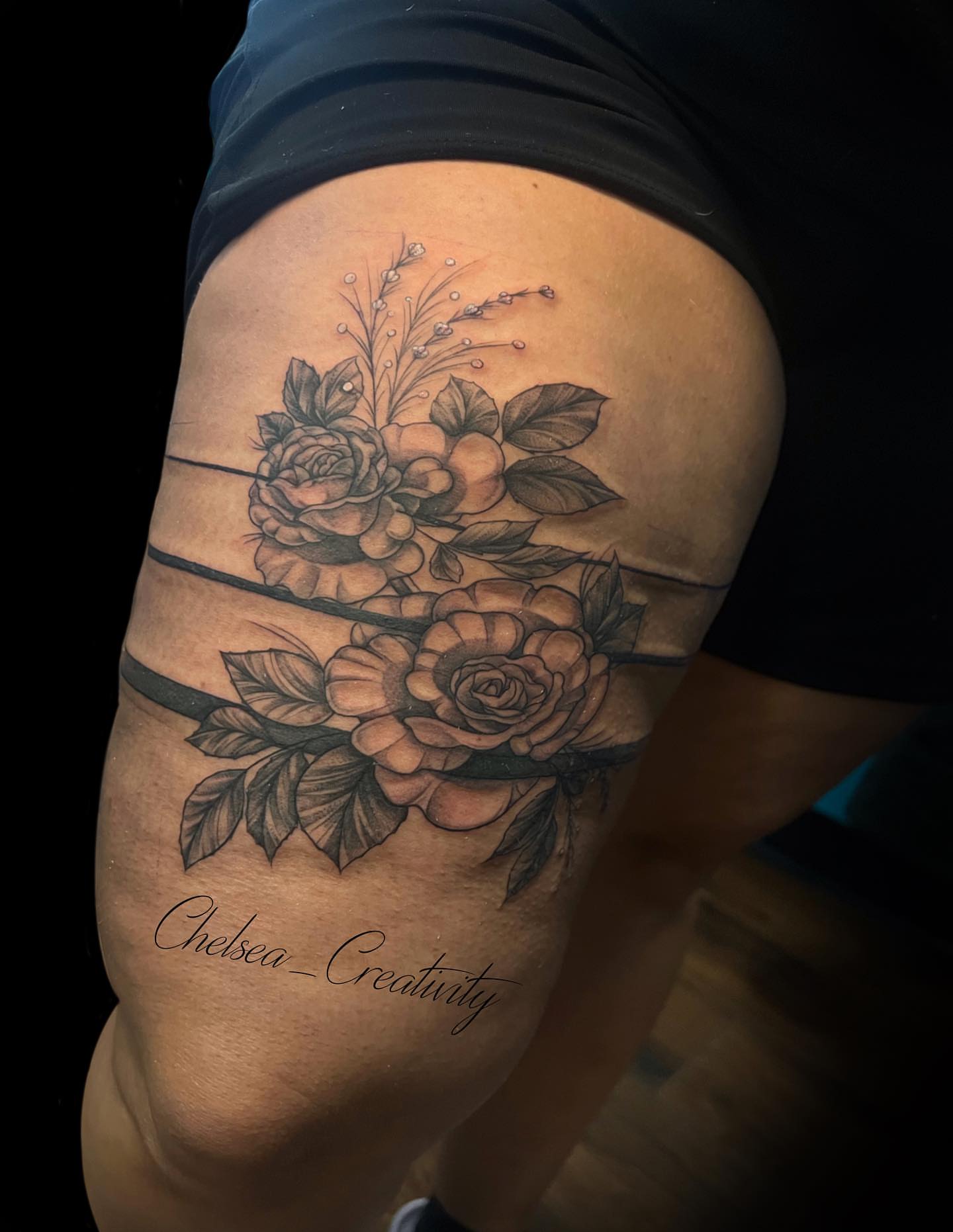 Floral bouquet realism tattoo on the thigh by Chelsea Nichole