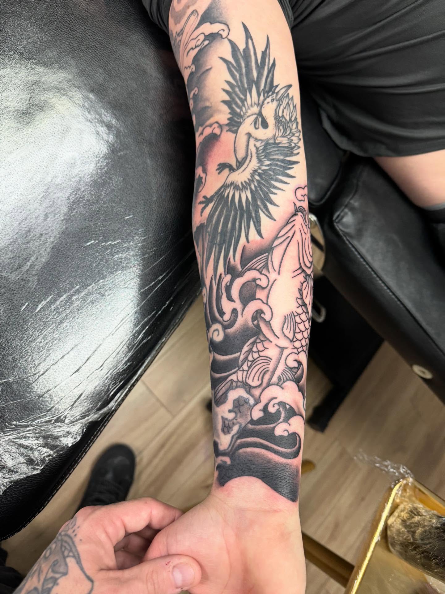Phoenix and dragon japanese irezumi tattoo on the forearm by Jon Fleming