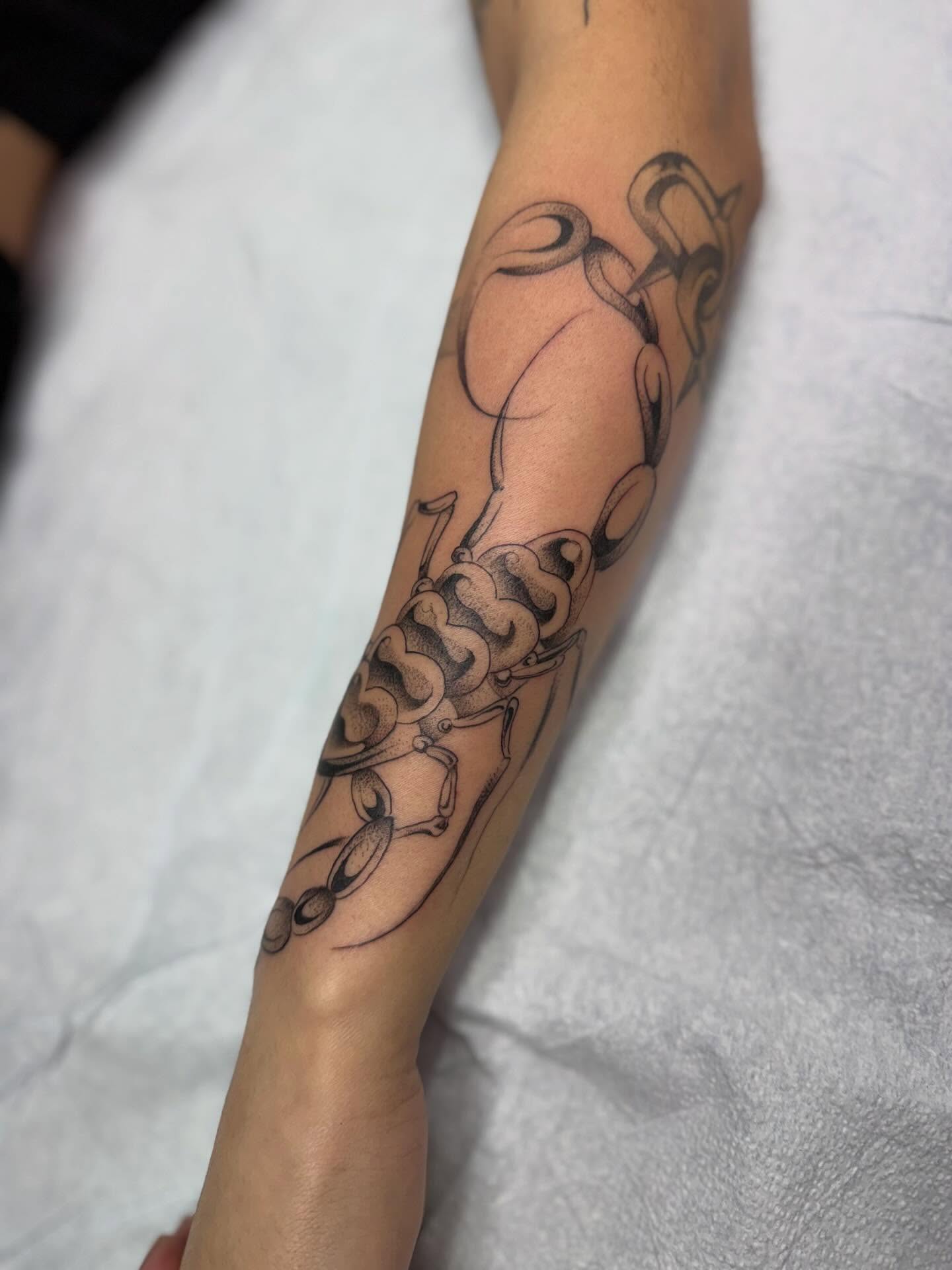 Scorpion black and grey tattoo on the forearm by christian martinez