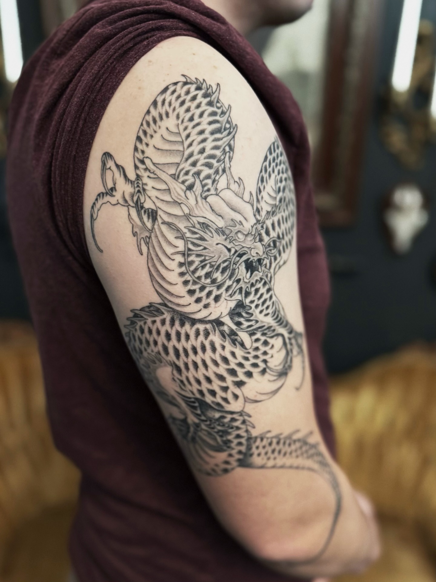 Dragon black and grey tattoo on the upper arm by Virginia 🥀Neo Traditional