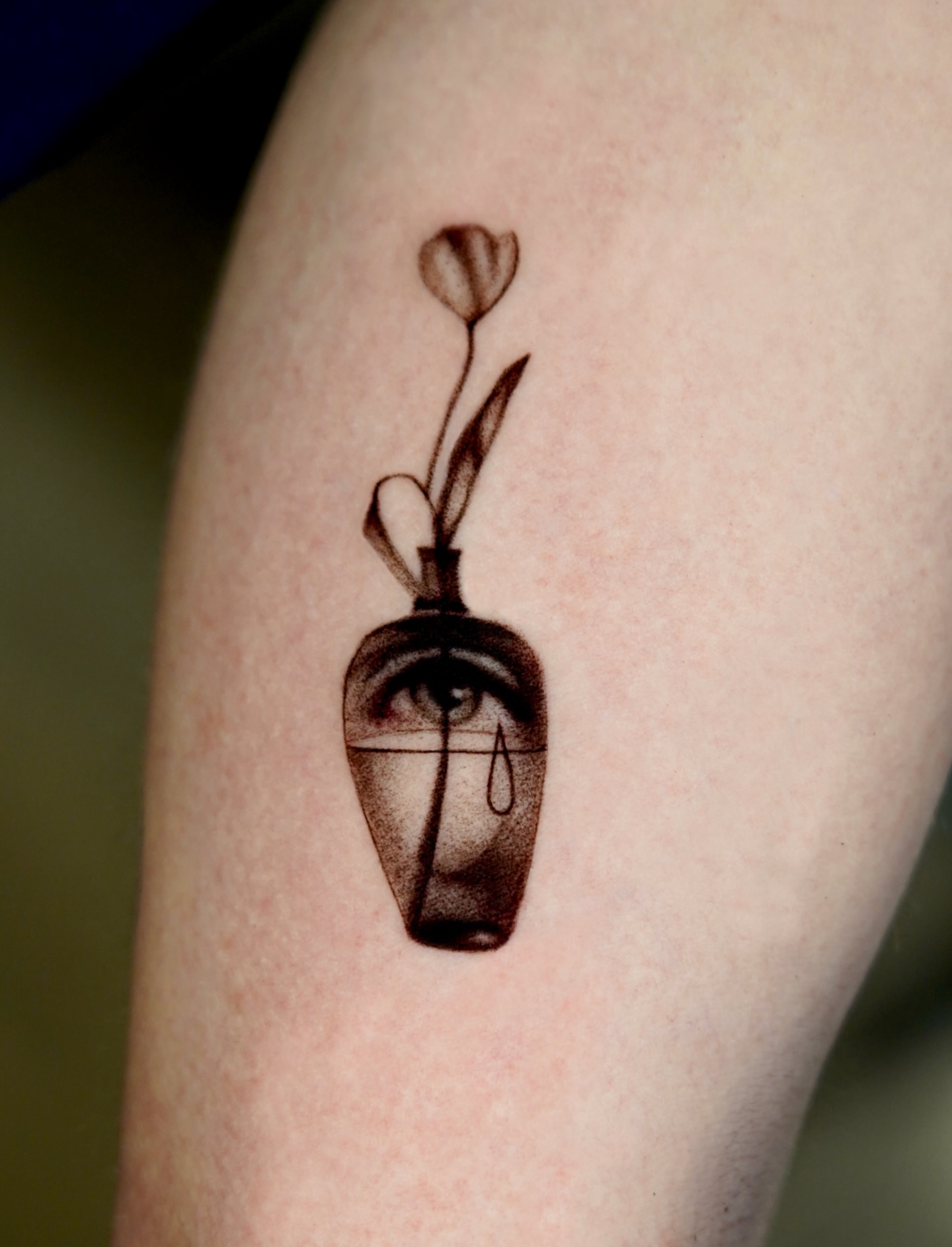Eye and tulips black and grey tattoo on the forearm by Metin Karaatli