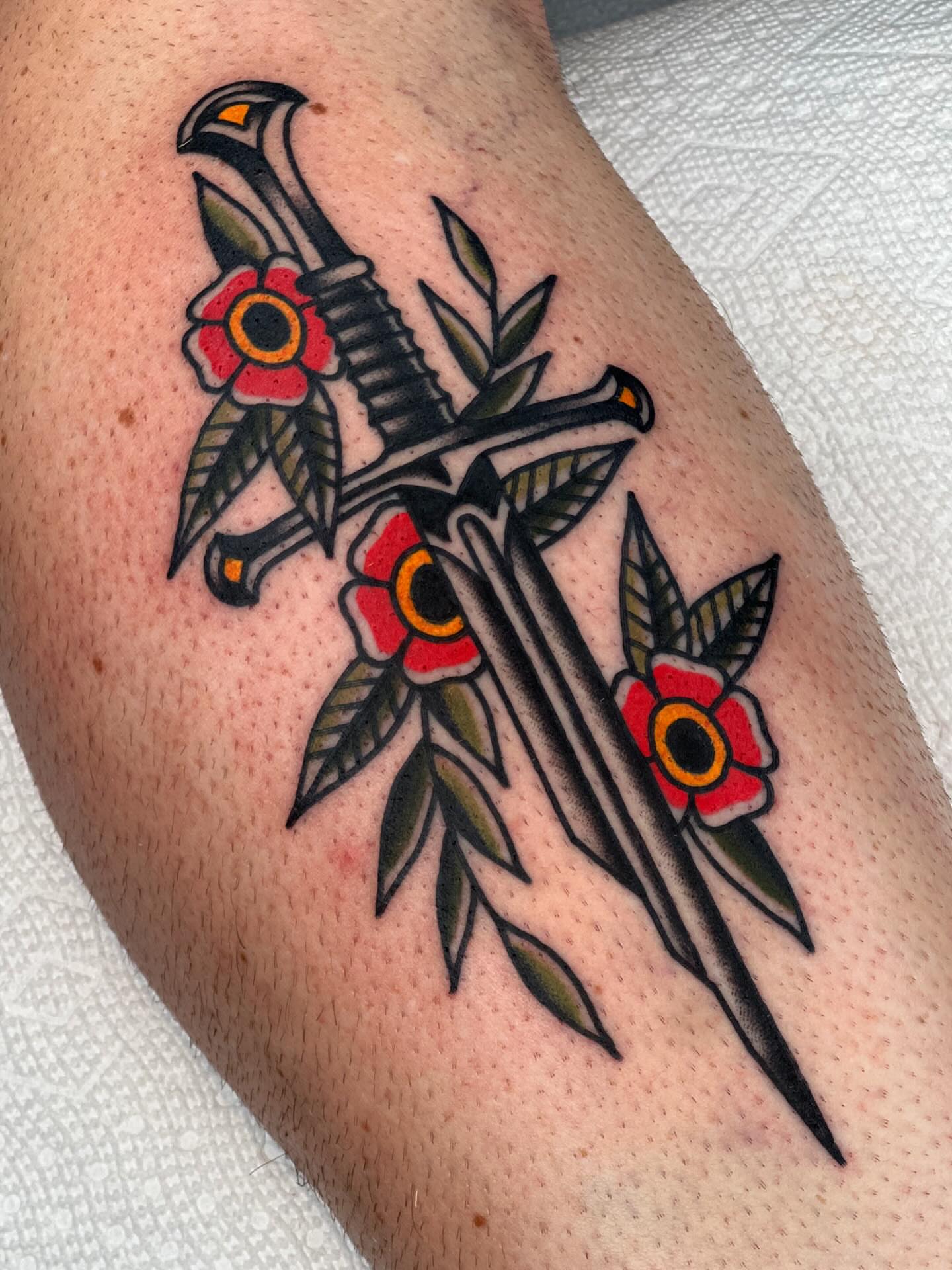 Sword and flowers American traditional tattoo on the forearm by Blake Francis, Worcester, Massachusetts