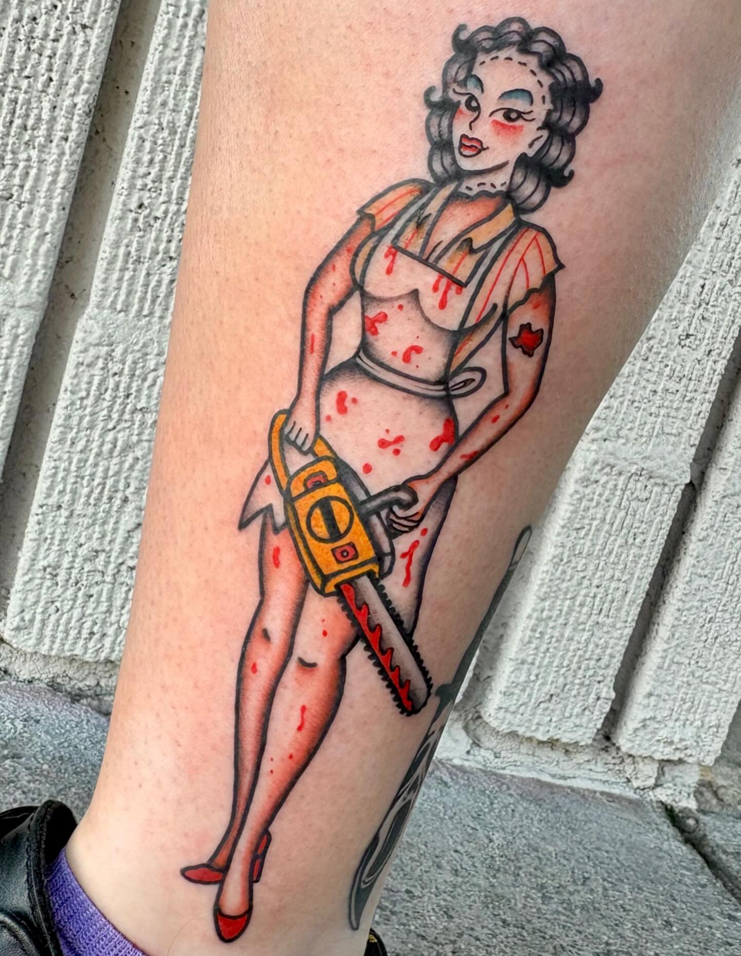 Pin-up nurse with chainsaw American traditional tattoo on the forearm by Carson Smith, Chandler, Arizona