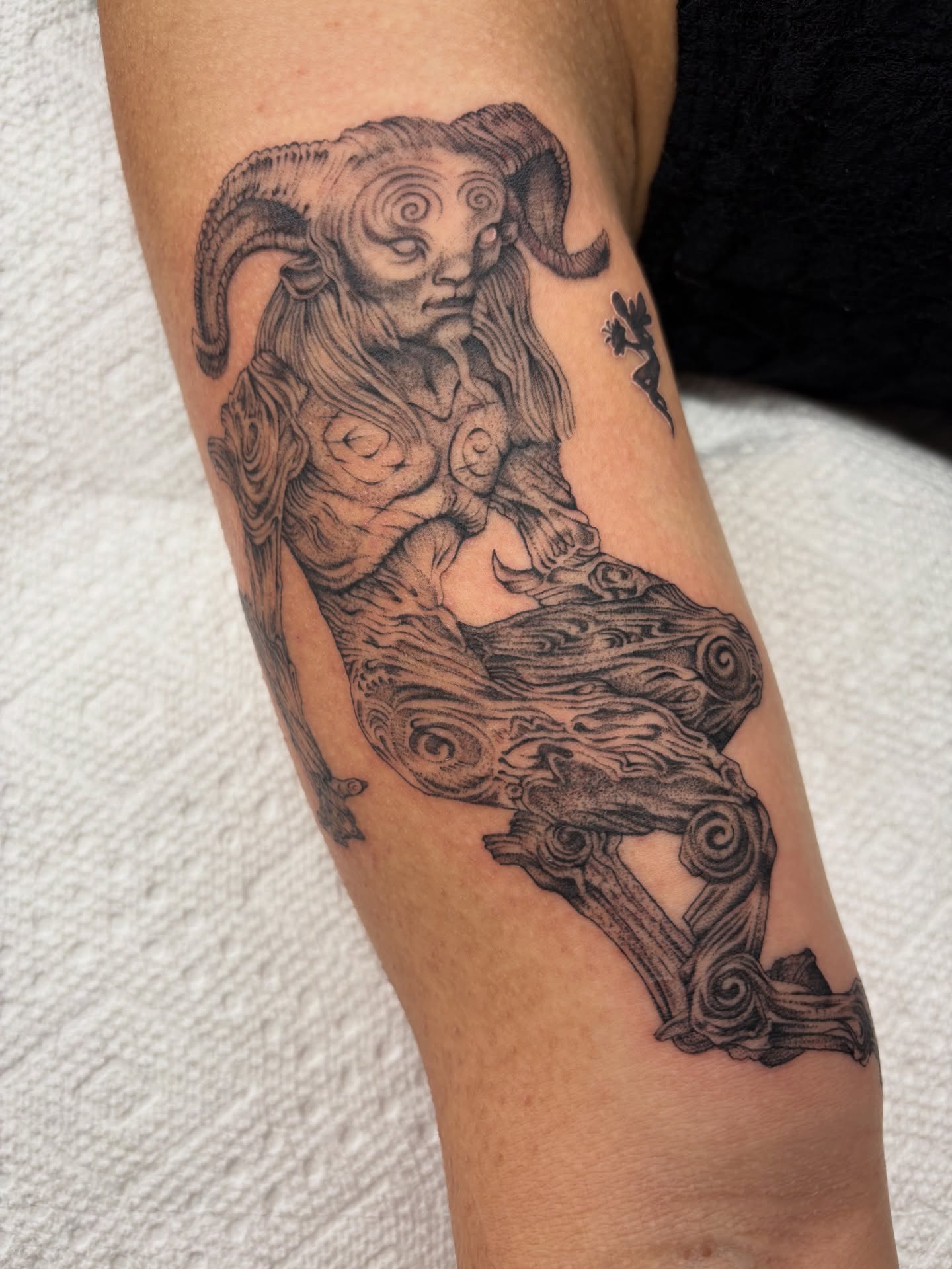 Ram black and grey tattoo on the forearm by Nori