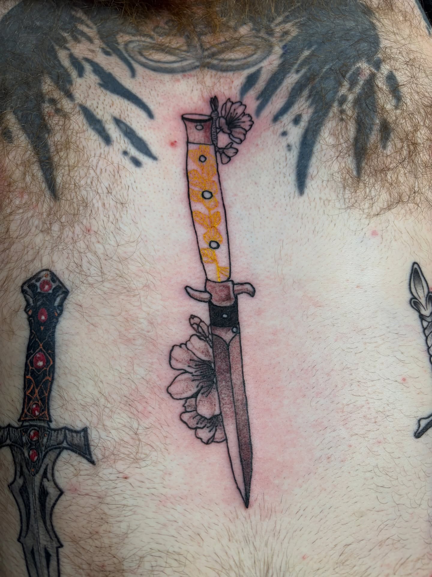 Knife with floral handle neo-traditional tattoo on the chest by Michelle