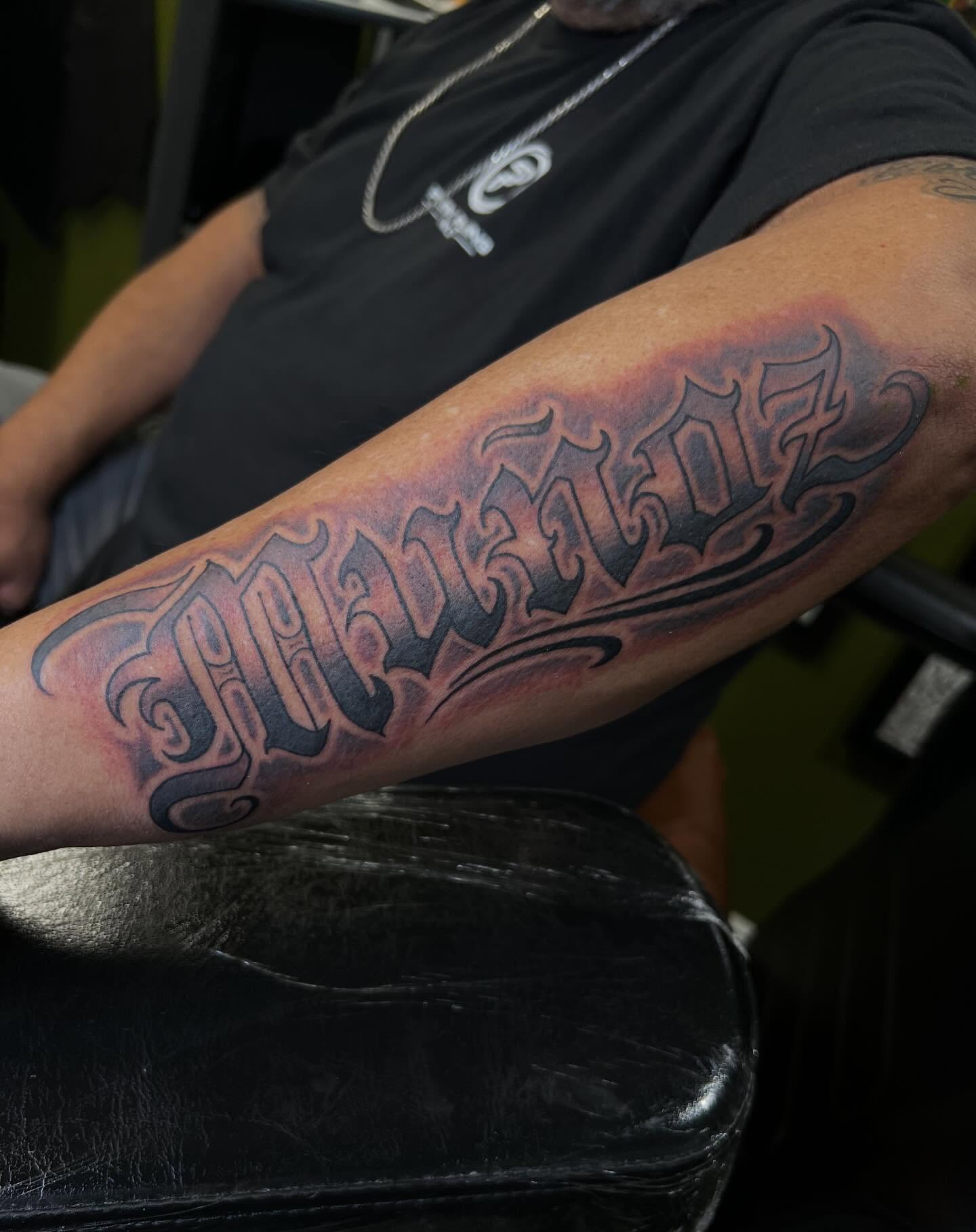 Script lettering lettering script tattoo on the forearm by Niz Carrillo