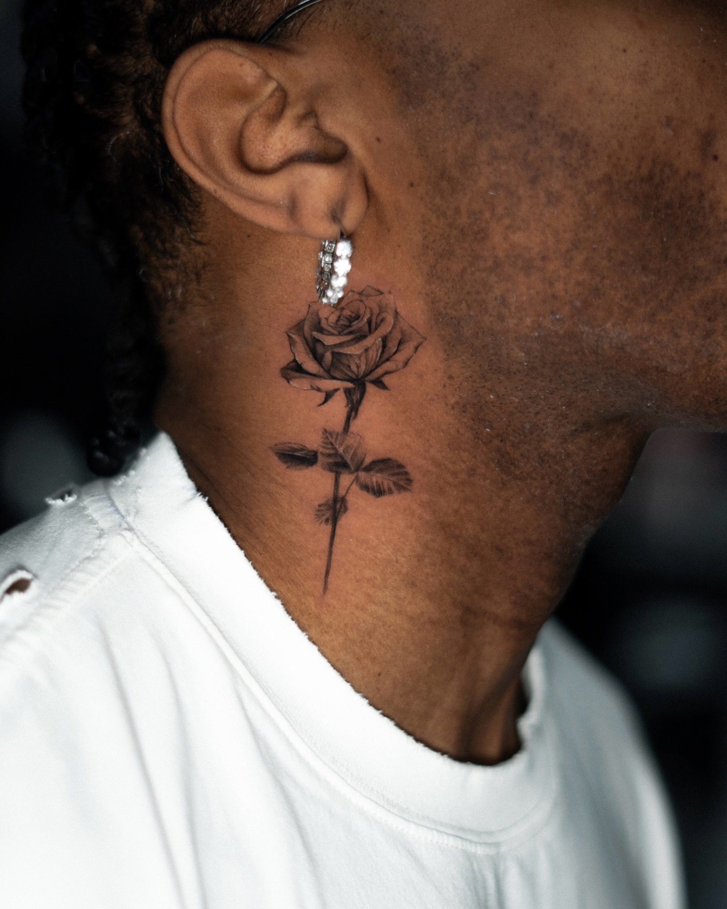 Rose black and grey tattoo on the neck by Ron Alvarez
