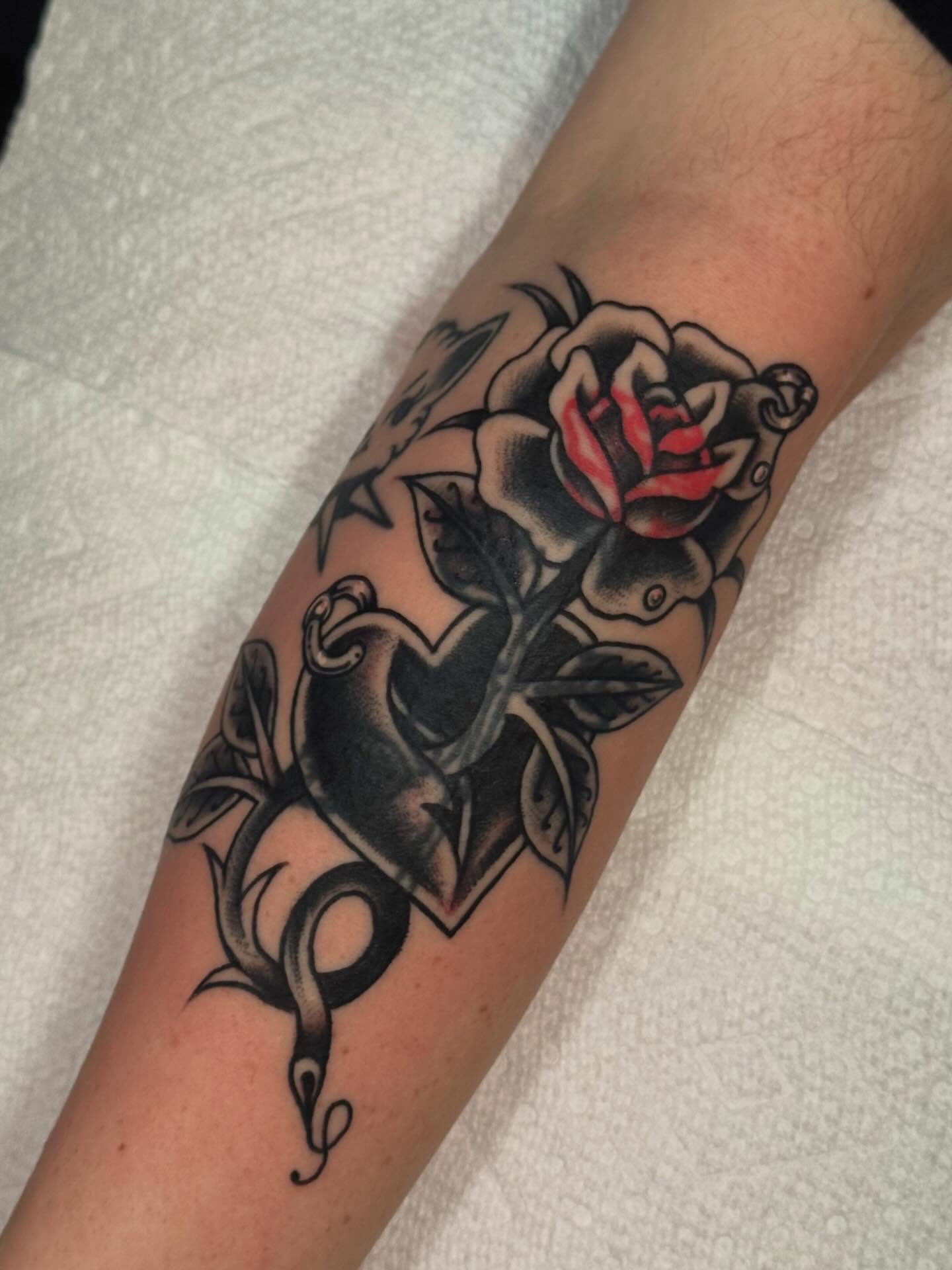 Rose and snake American traditional tattoo on the forearm by Painted Peach Tattooer