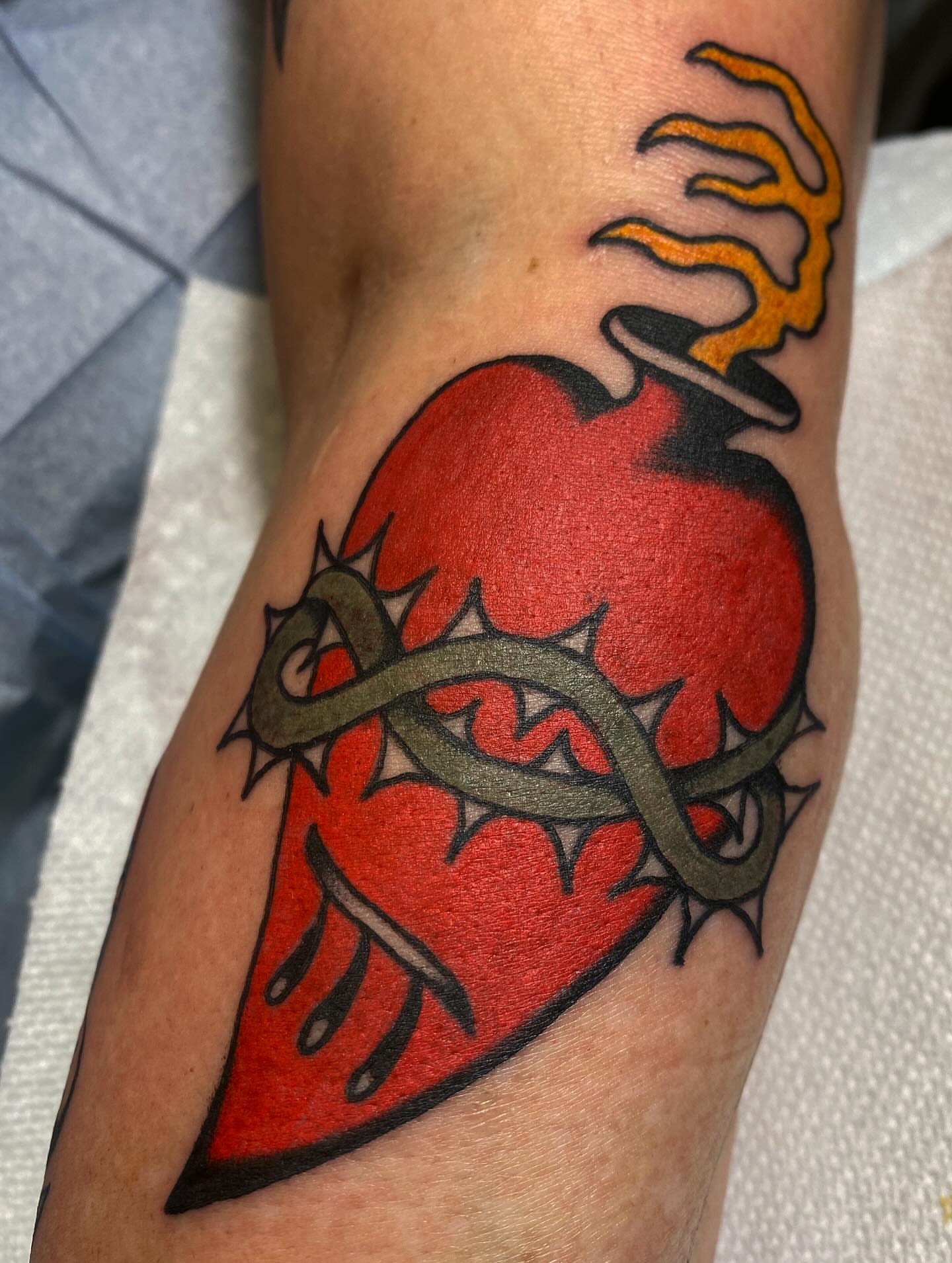 Heart with snake American traditional tattoo on the forearm by Abby Rose Estes