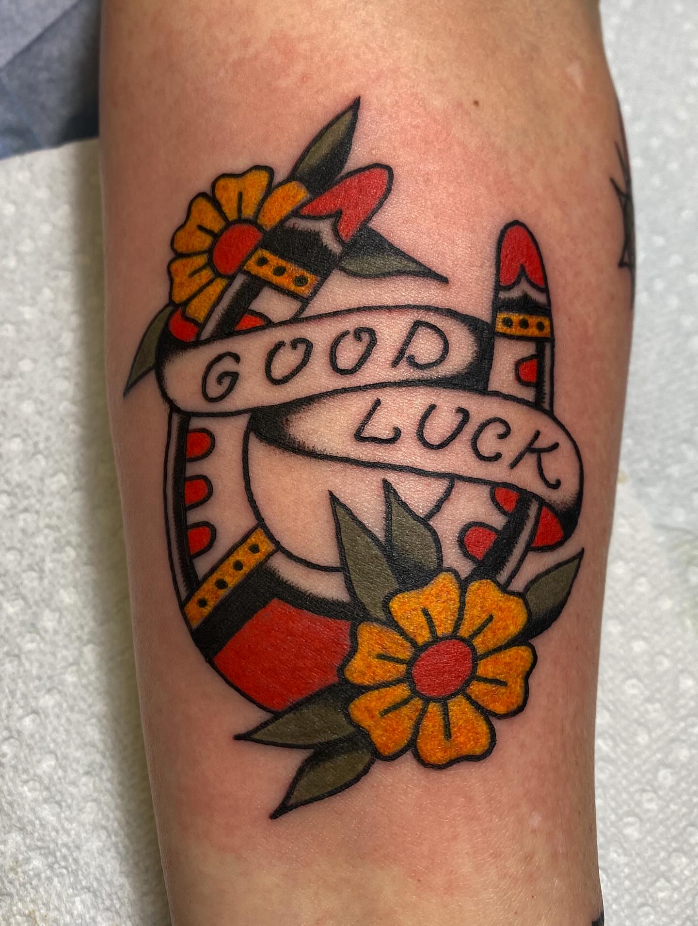 Good luck banner American traditional tattoo on the forearm by Abby Rose Estes