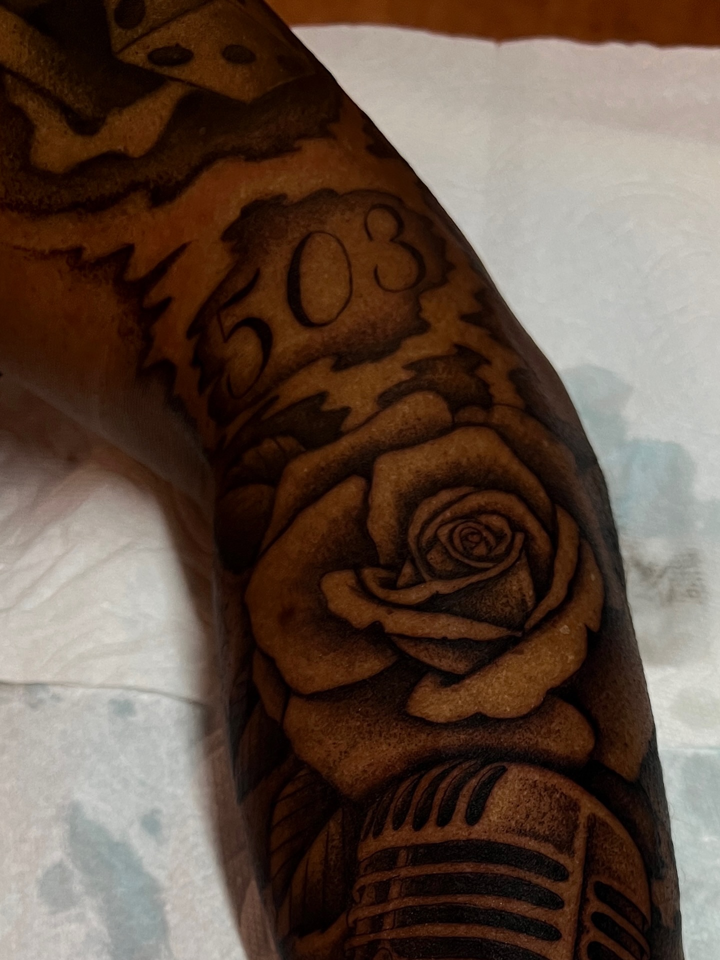 Rose black and grey tattoo on the forearm by David Delacruz