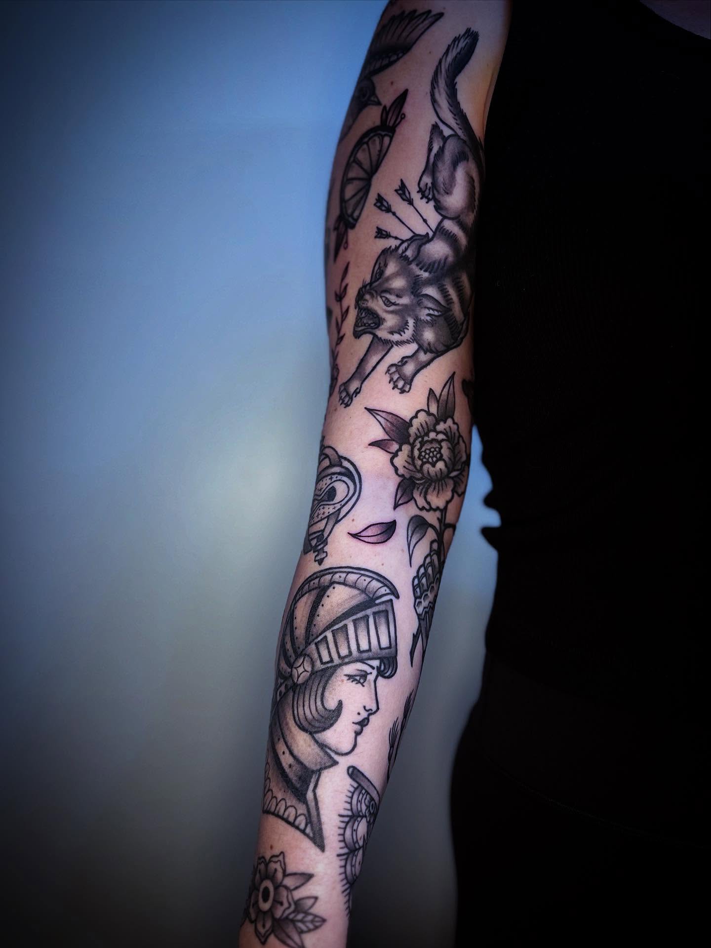 Woman with helmet and flowers American traditional tattoo on the forearm by Eden H., Columbus, Ohio