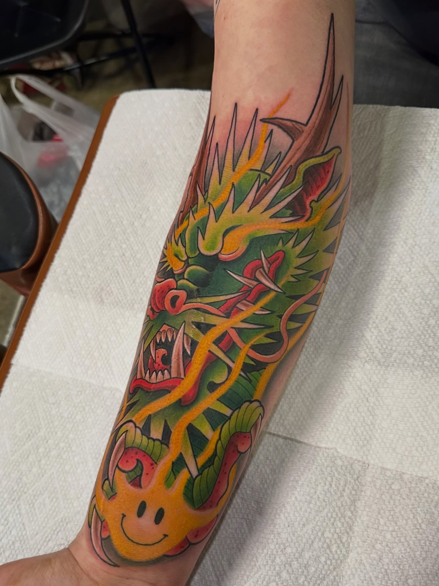 Dragon American traditional tattoo on the forearm by Trevor Burtz