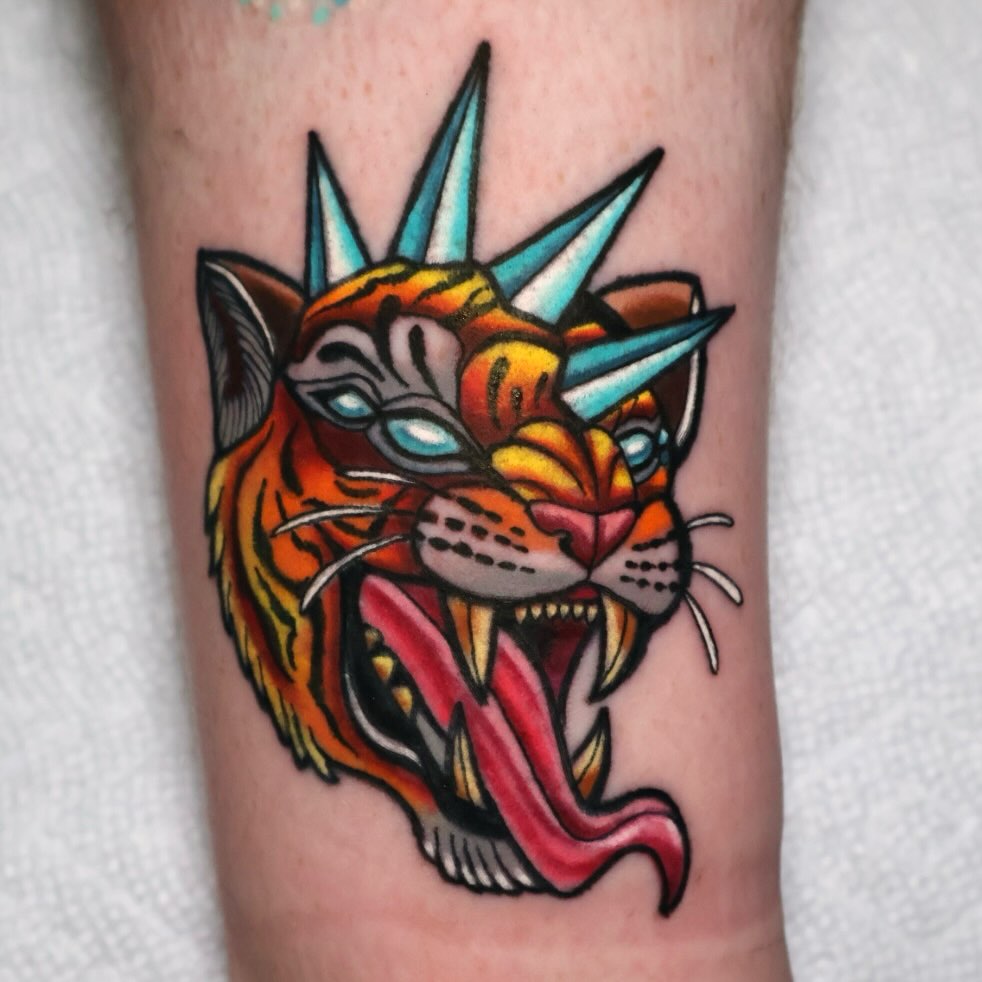 Tiger head American traditional tattoo on the forearm by Bailey Drey