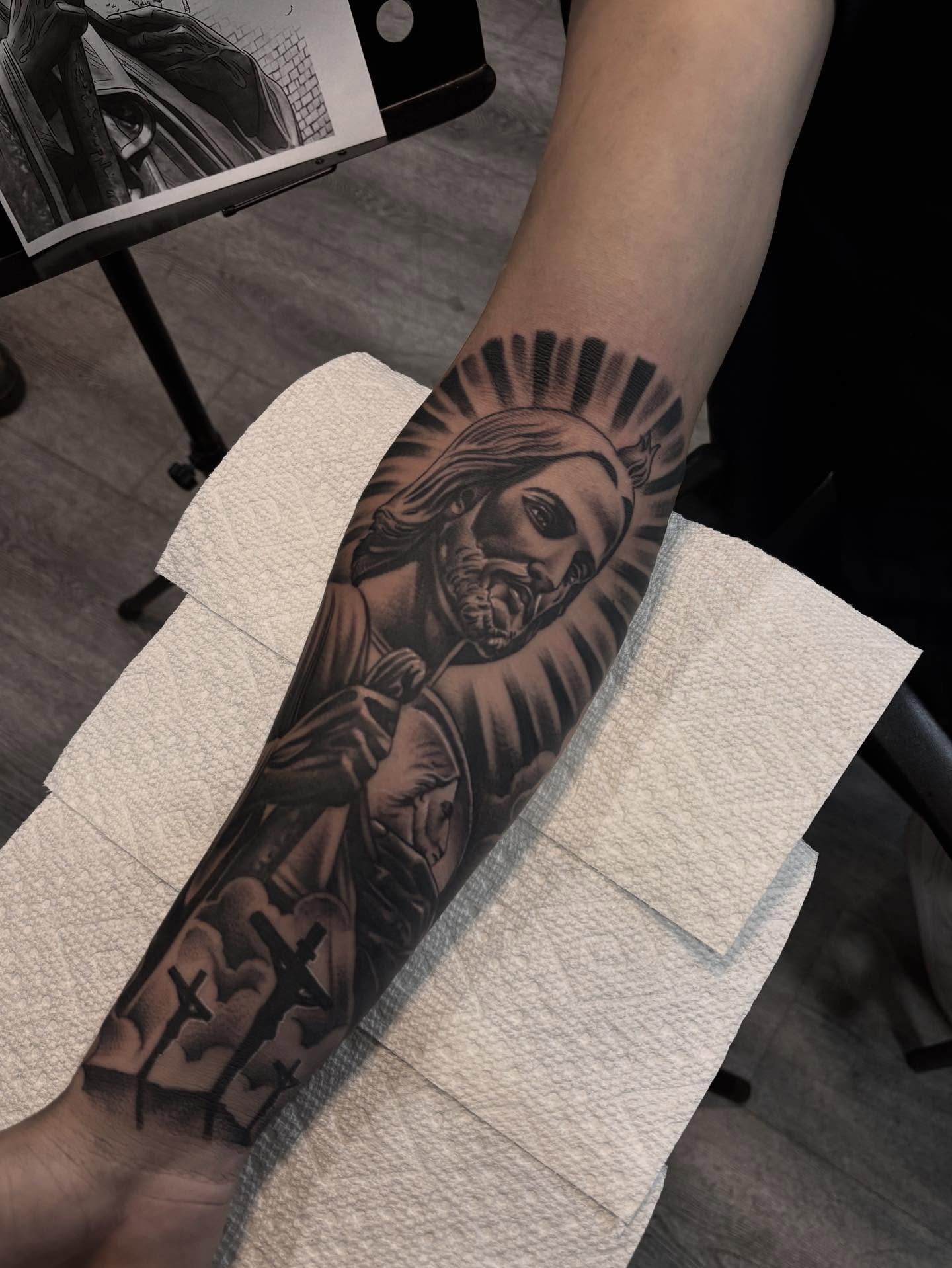 Religious figure black and grey tattoo on the forearm by michael