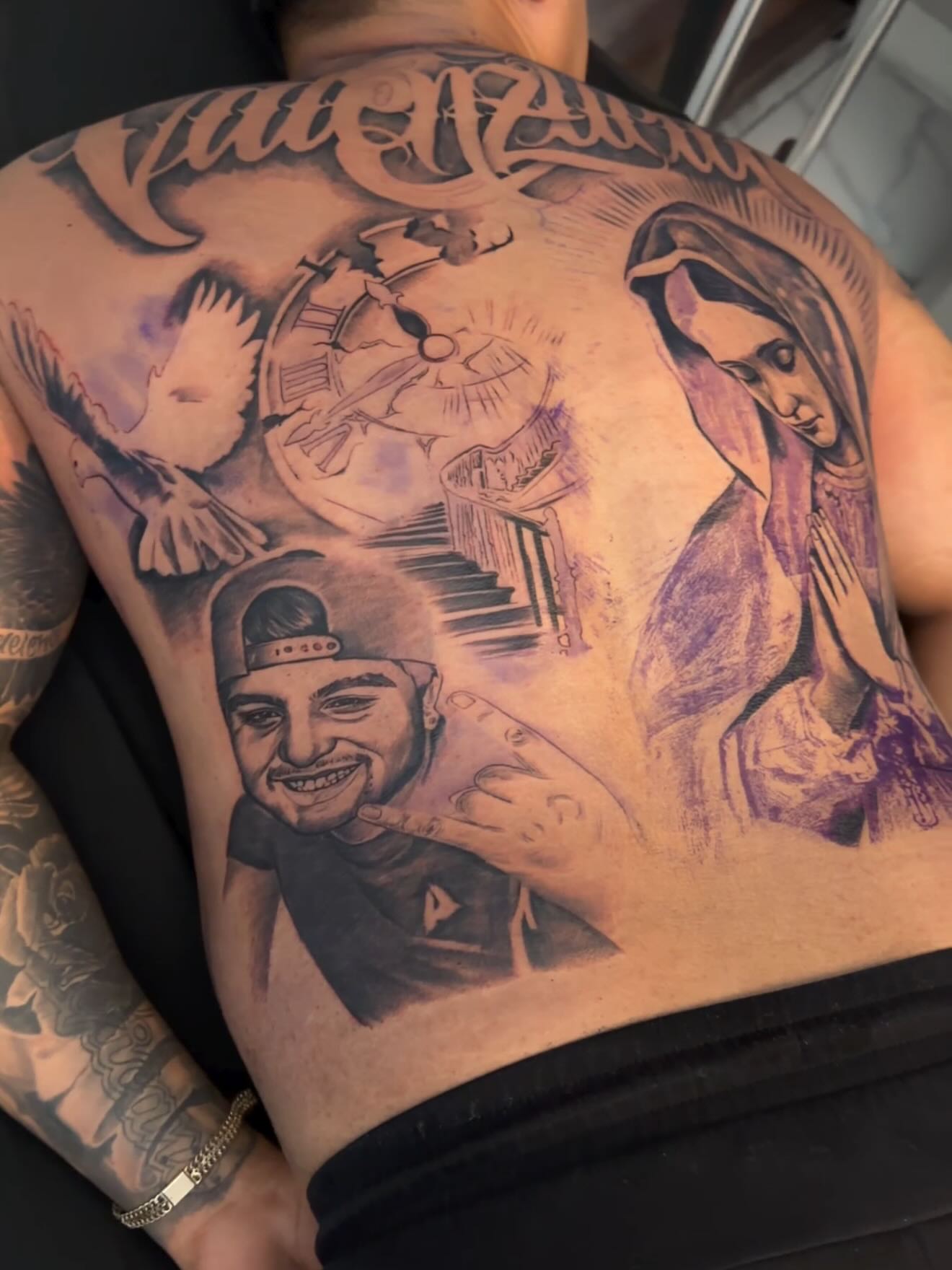 Religious figure and portrait black and grey tattoo on the back by Adrian gonzalez...