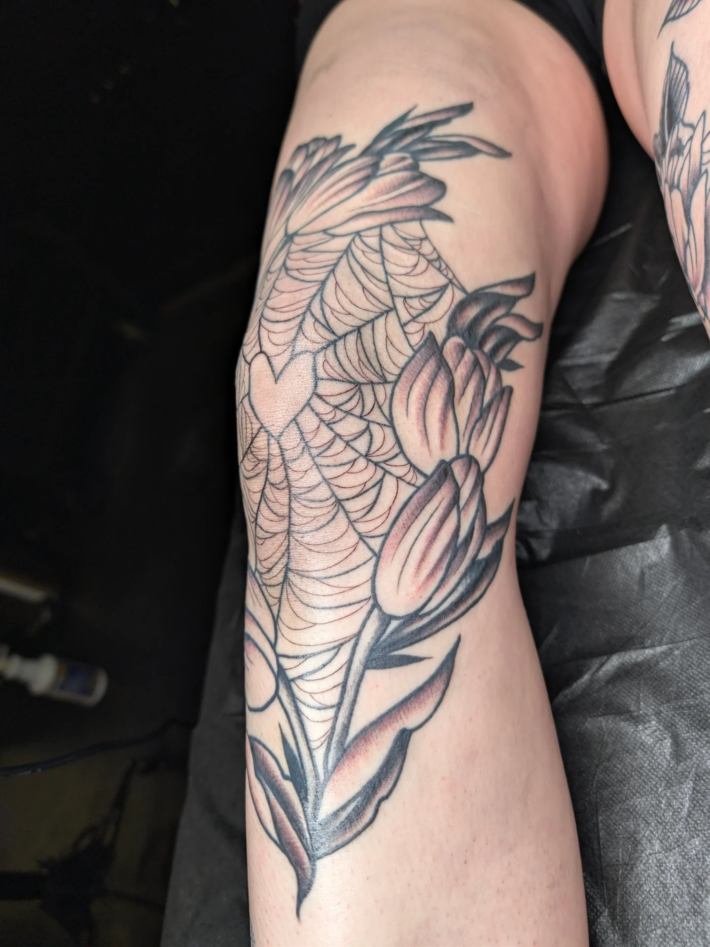 Koi fish and tulip realism tattoo on the forearm by Aiden Krone, San Diego, California