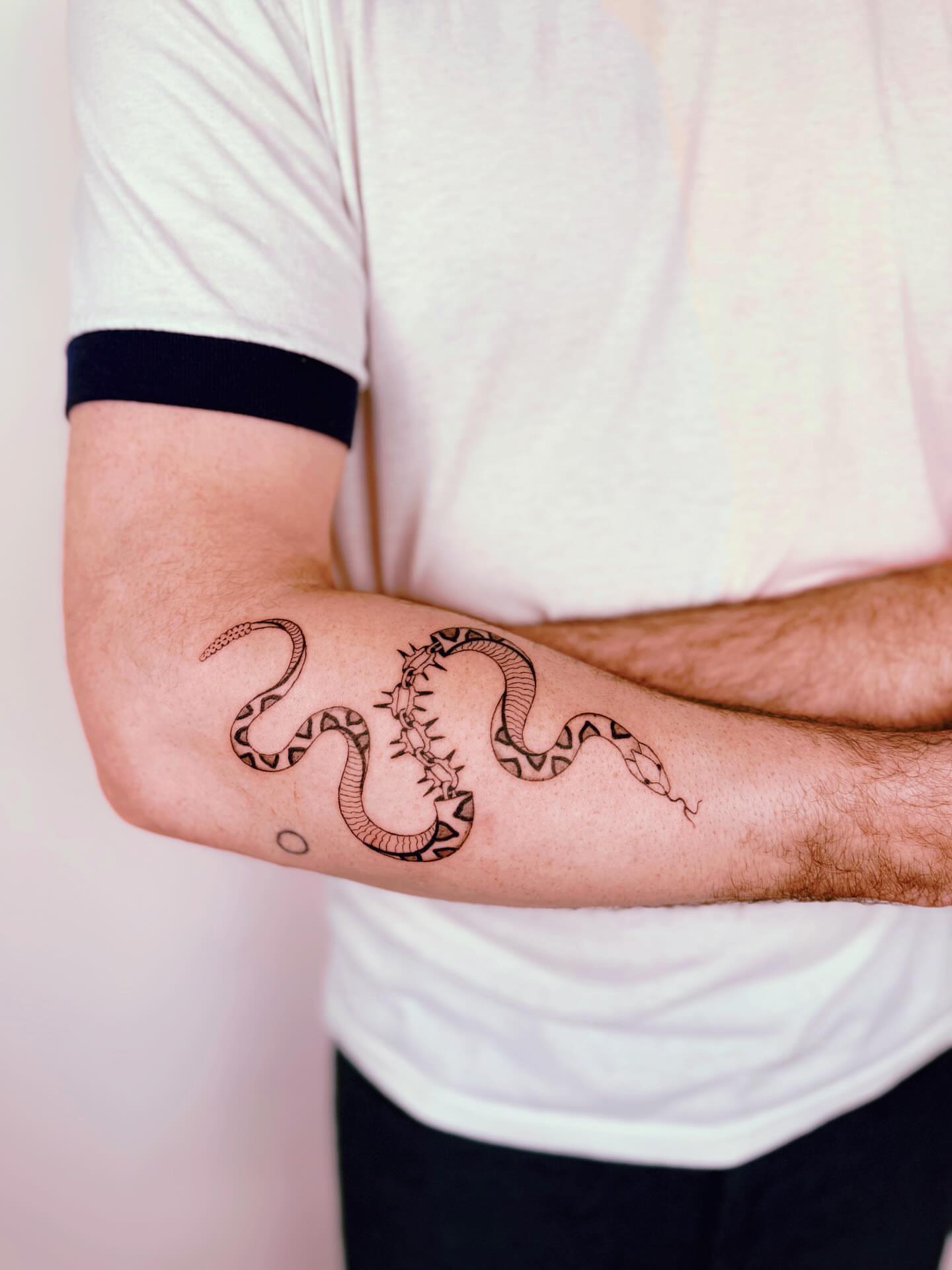 Snake black and grey tattoo on the forearm by b i l l i e, Seattle, Washington