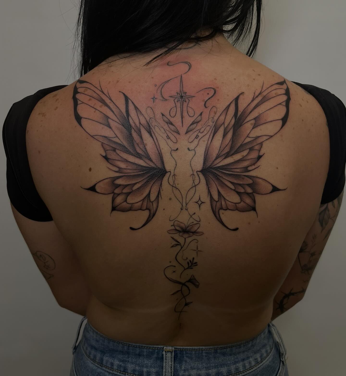 Winged creature geometric tattoo on the back by kaylee