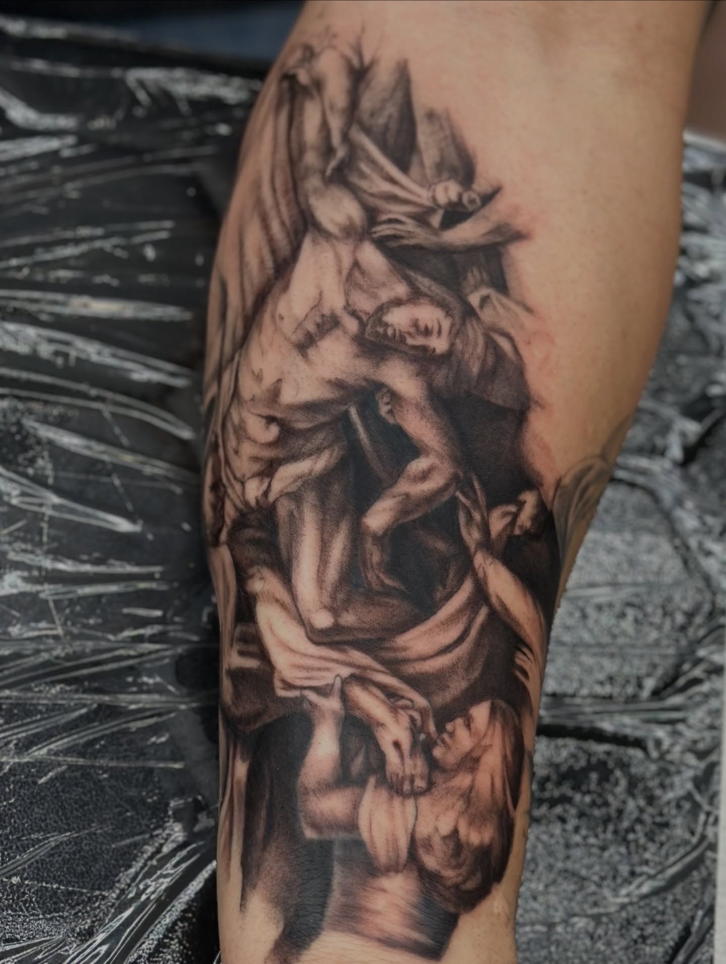 Religious scene realism tattoo on the forearm by Trent Hebert
