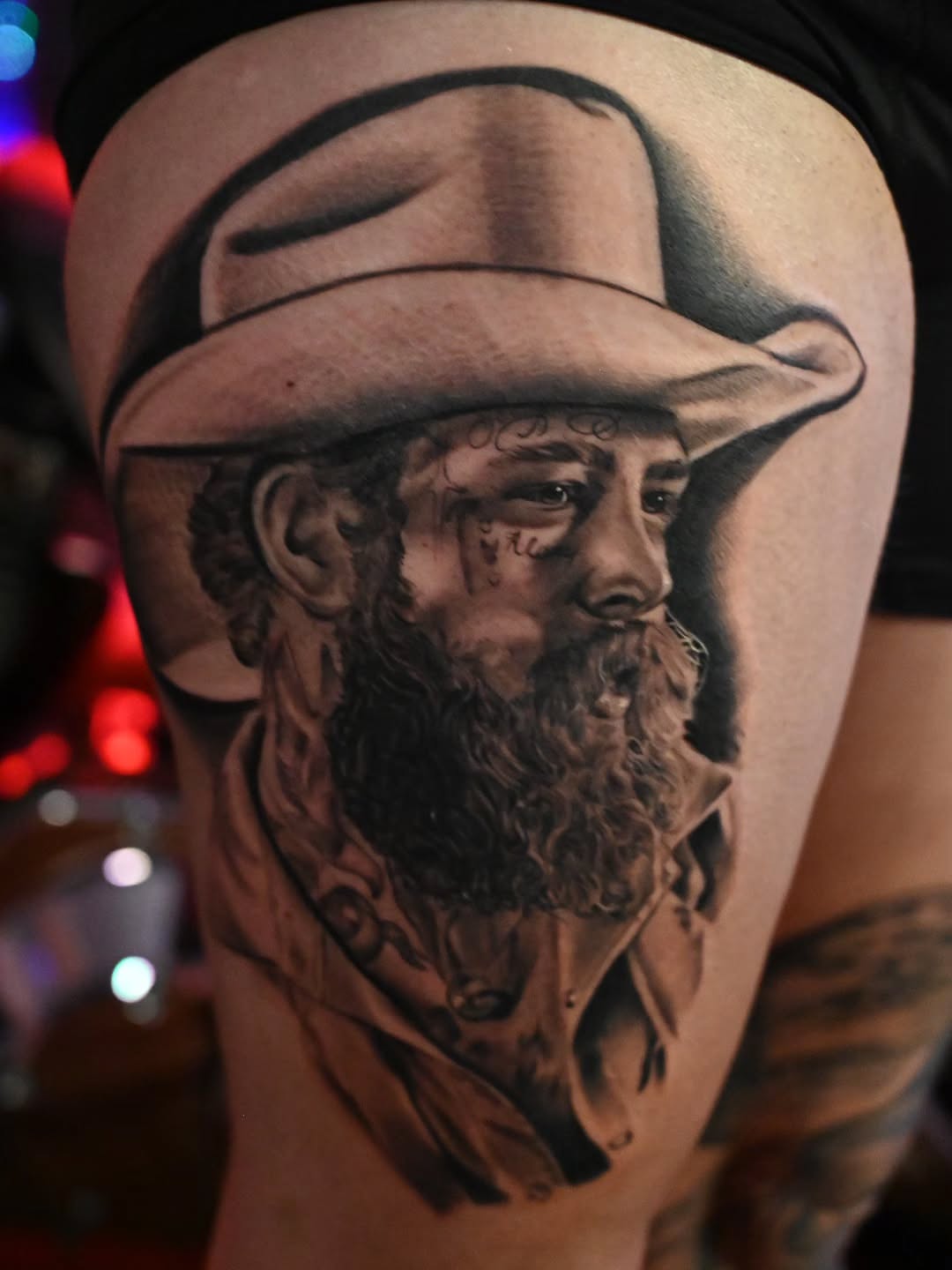 Man with cowboy hat realism tattoo on the thigh by Michael ORegan
