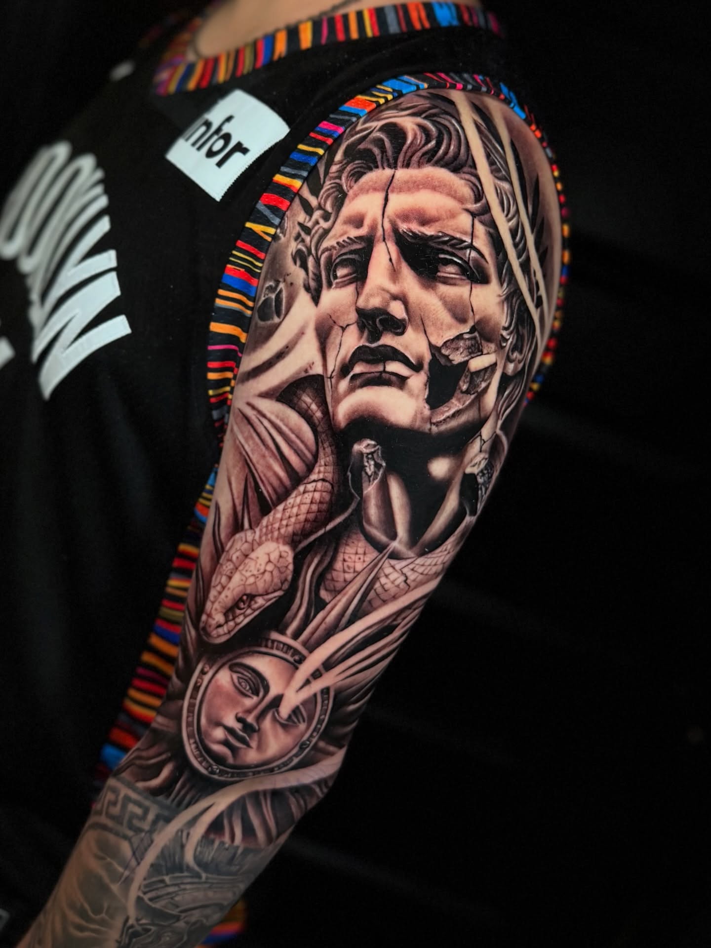Man's face with snake realism tattoo on the forearm by Sebastian Calderon
