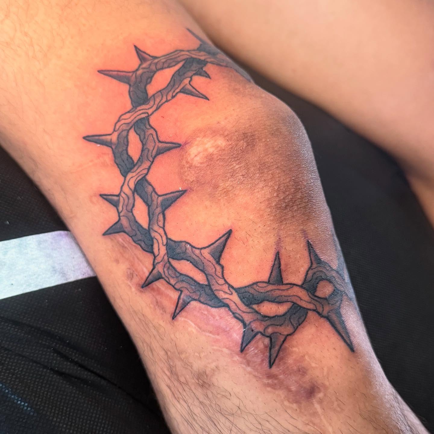Crown of thorns black and grey tattoo on the forearm by Zac Chaffin