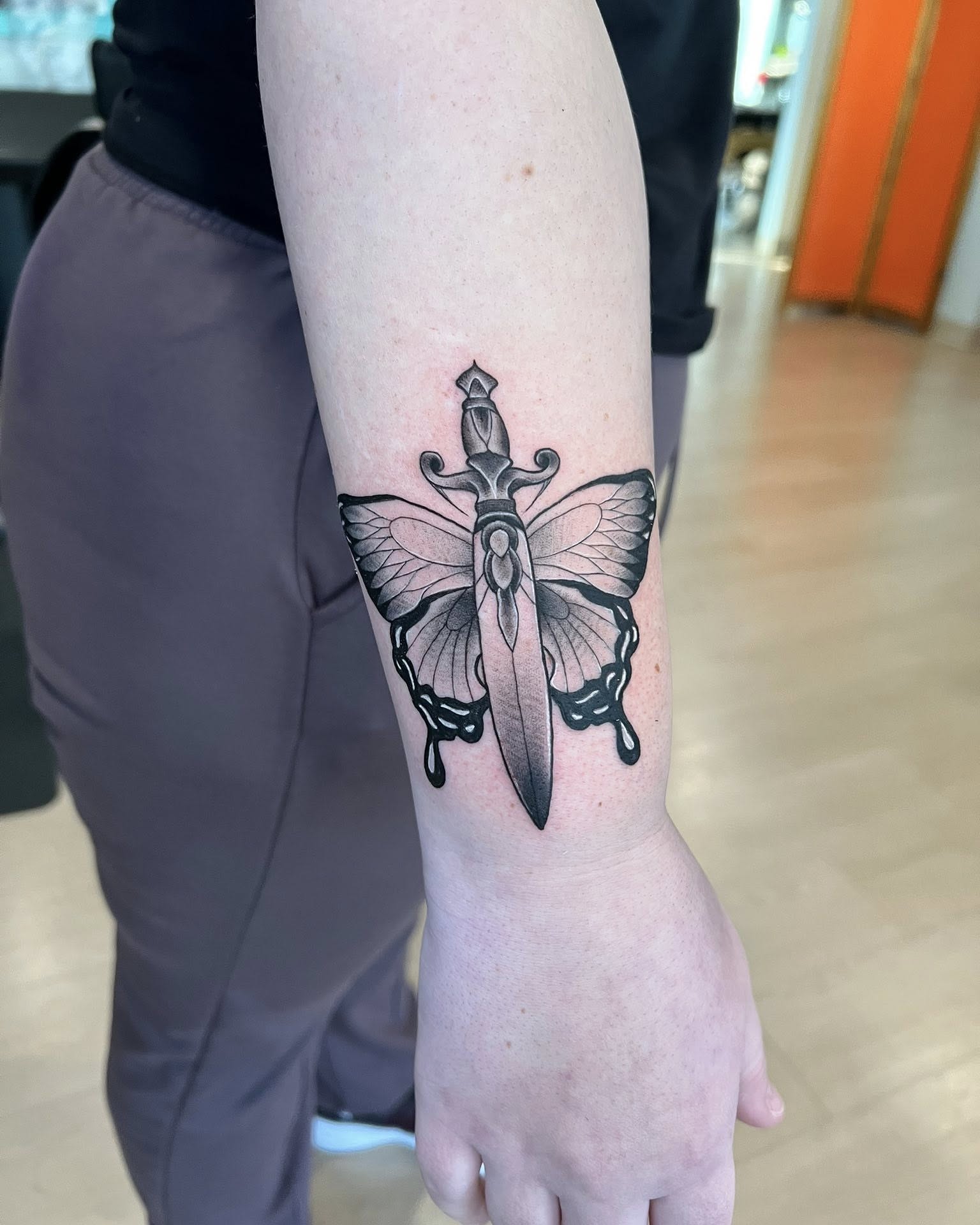 Butterfly knife black and grey tattoo on the forearm by Jessica Kloos