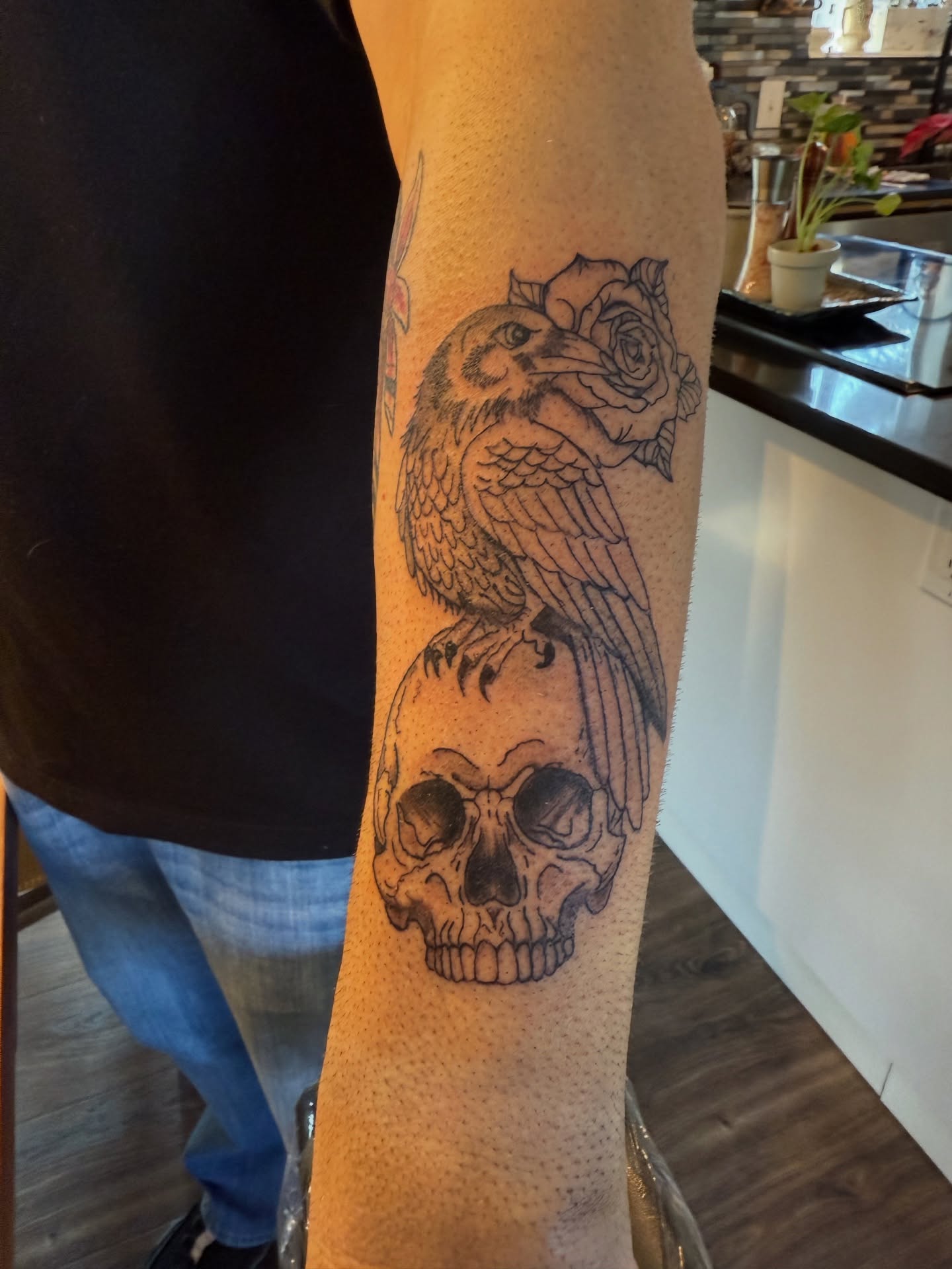 Skull and bird realism tattoo on the forearm by Whimsy Ink