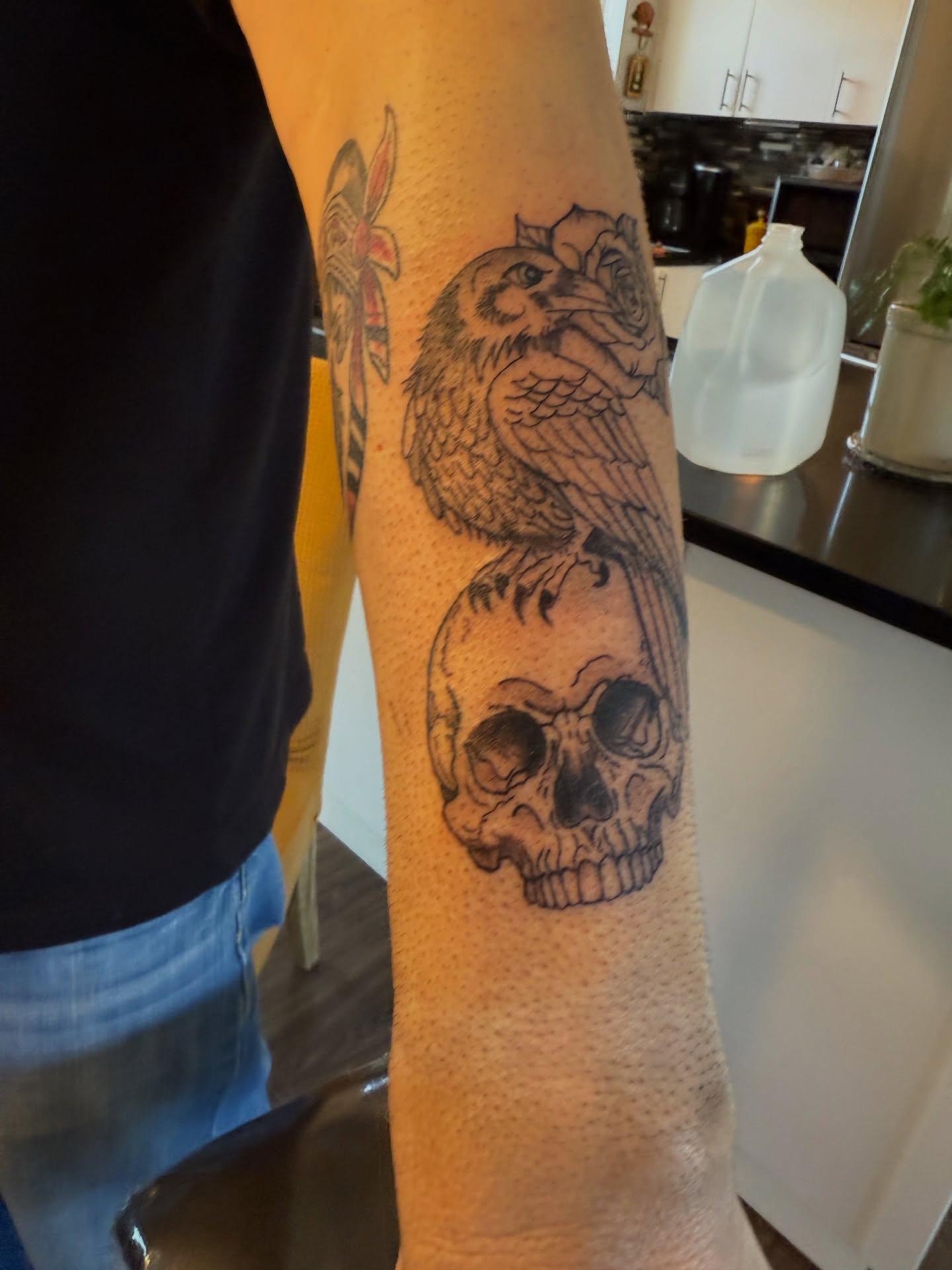Skull and bird black and grey tattoo on the forearm by Whimsy Ink