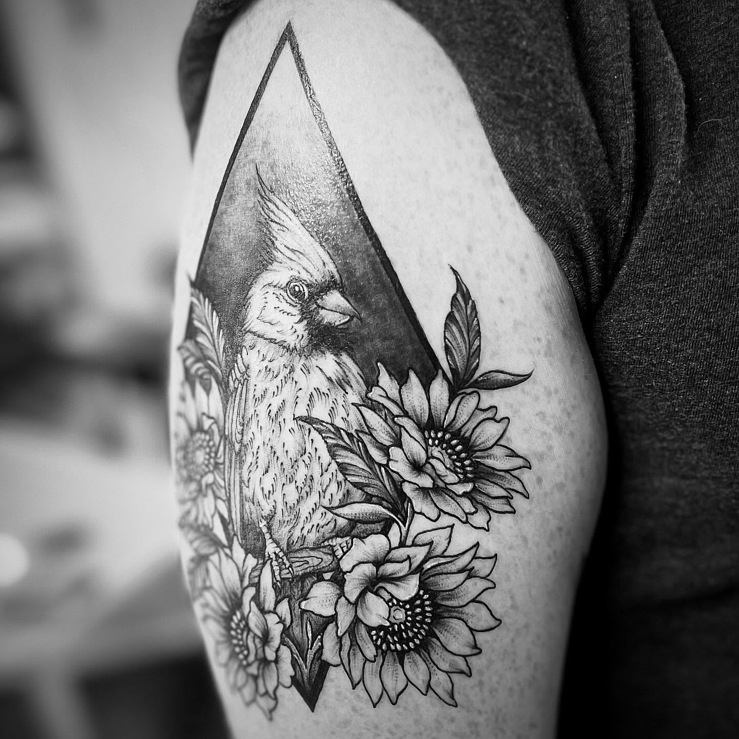 Cardinal and sunflowers dotwork tattoo on the shoulder by Rikki