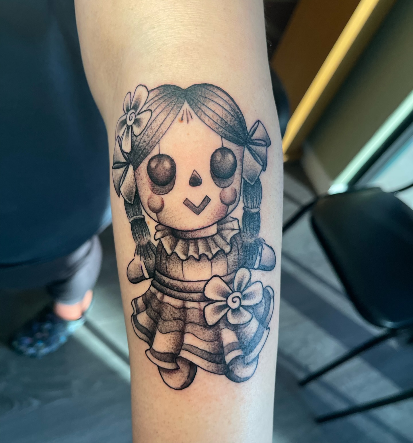 Rag doll black and grey tattoo on the forearm by Alex