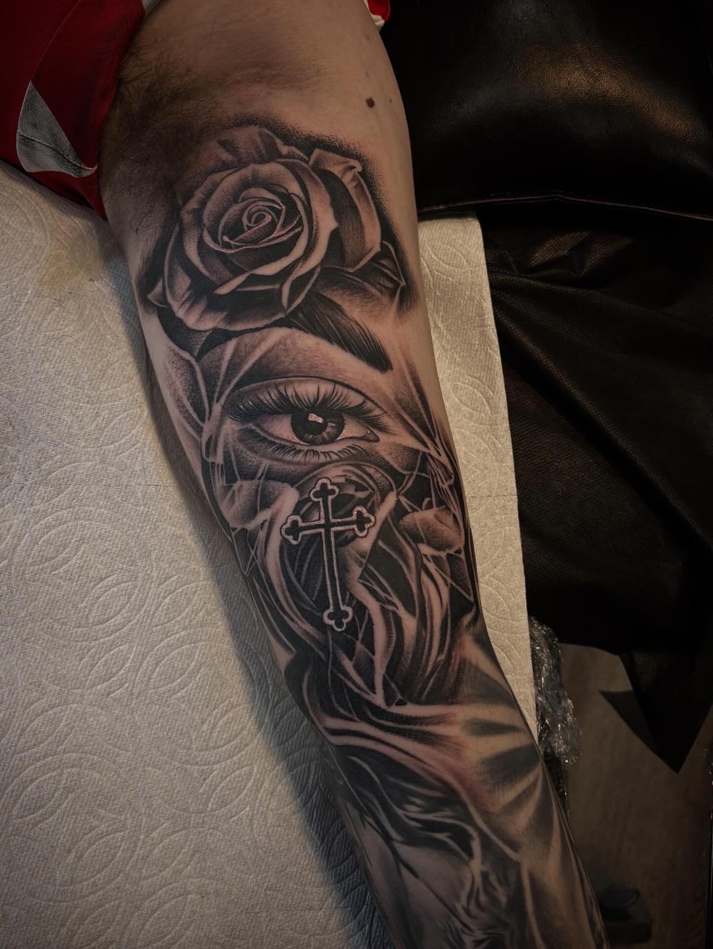 Eye and rose realism tattoo on the forearm by michael