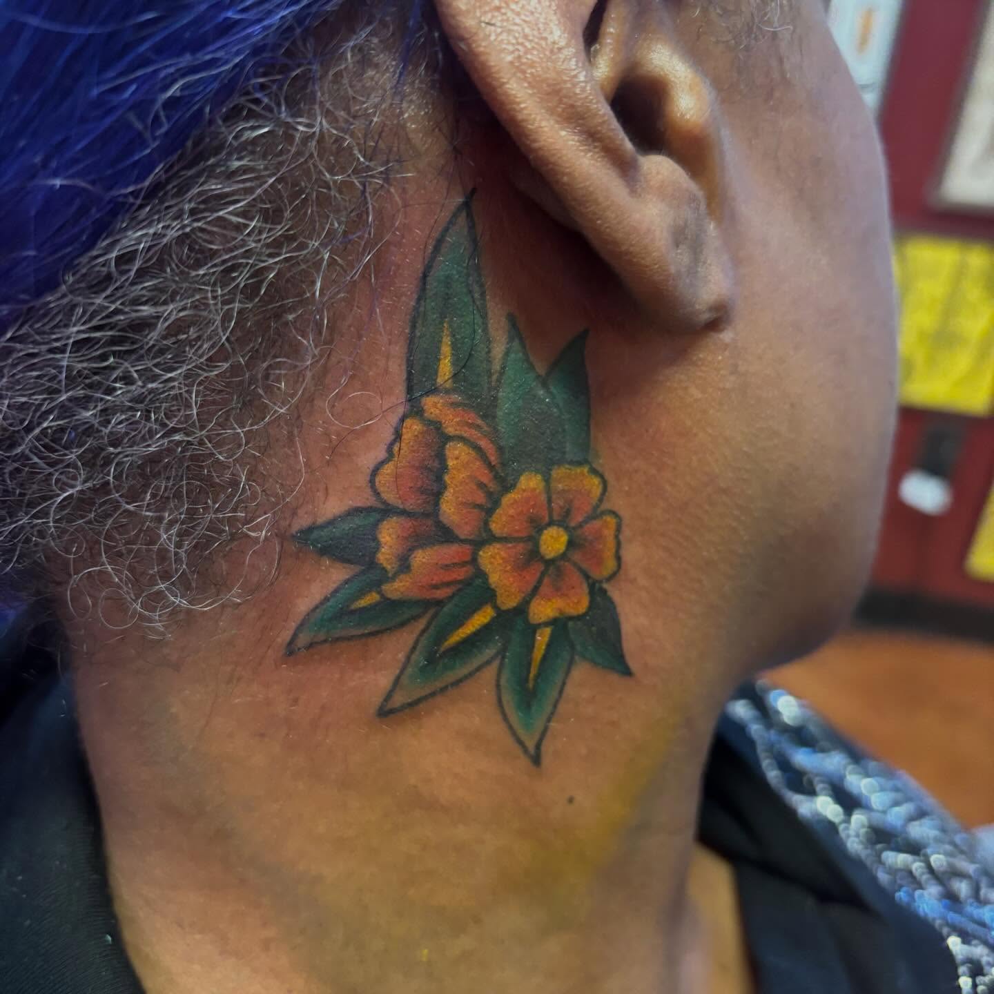 Flower neo-traditional tattoo on the neck by Angie Isbell