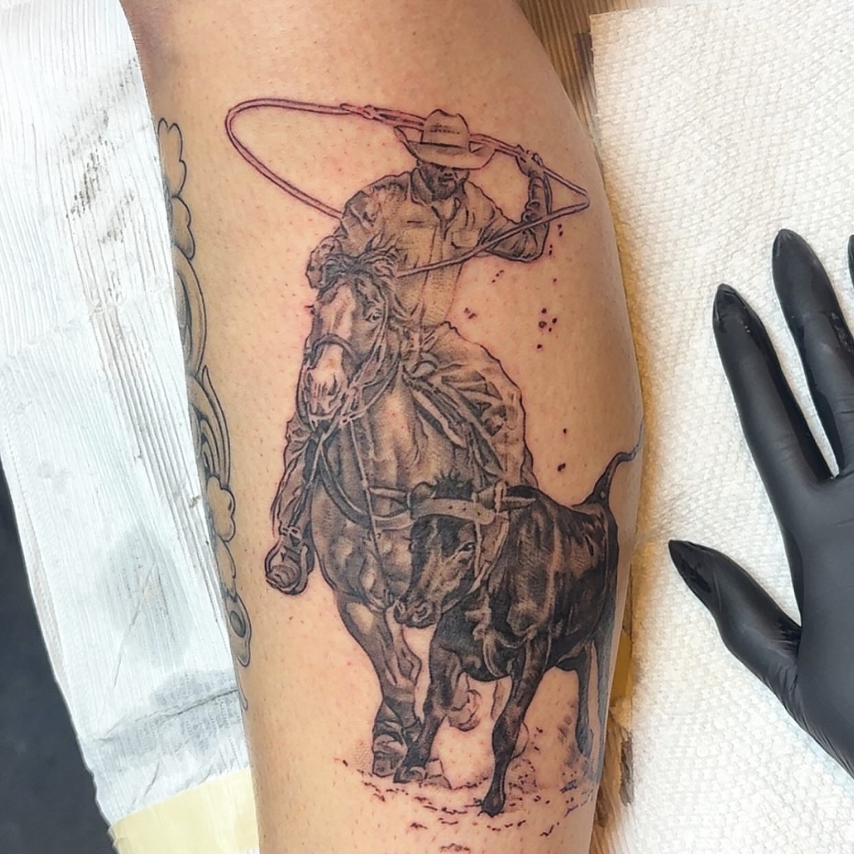 Cowboy roping calf realism tattoo on the forearm by Adriana Wimler