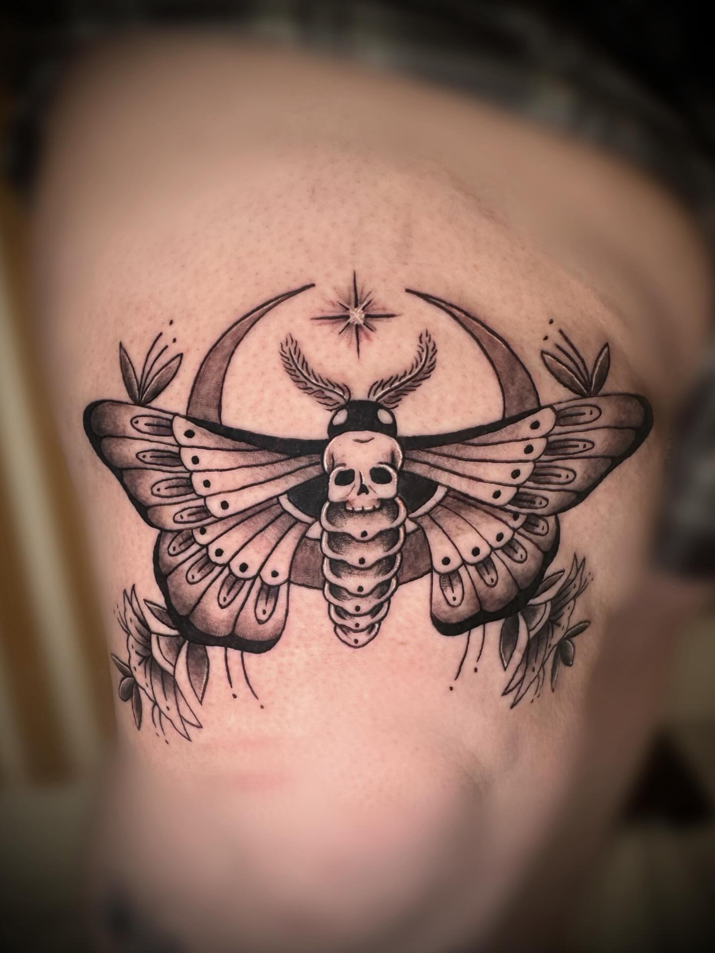 Moth skull black and grey tattoo on the shoulder by Saint