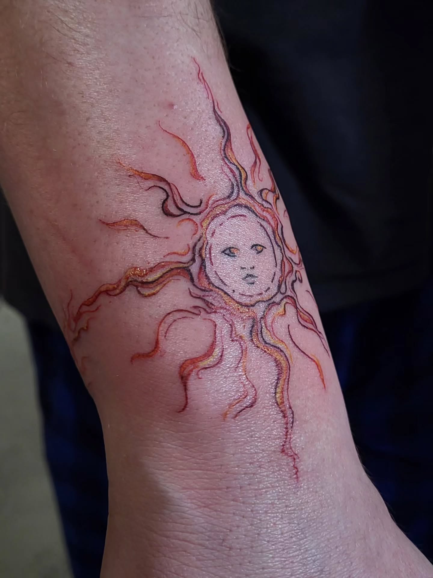 Sun neo-traditional tattoo on the forearm by Lydia Kiley