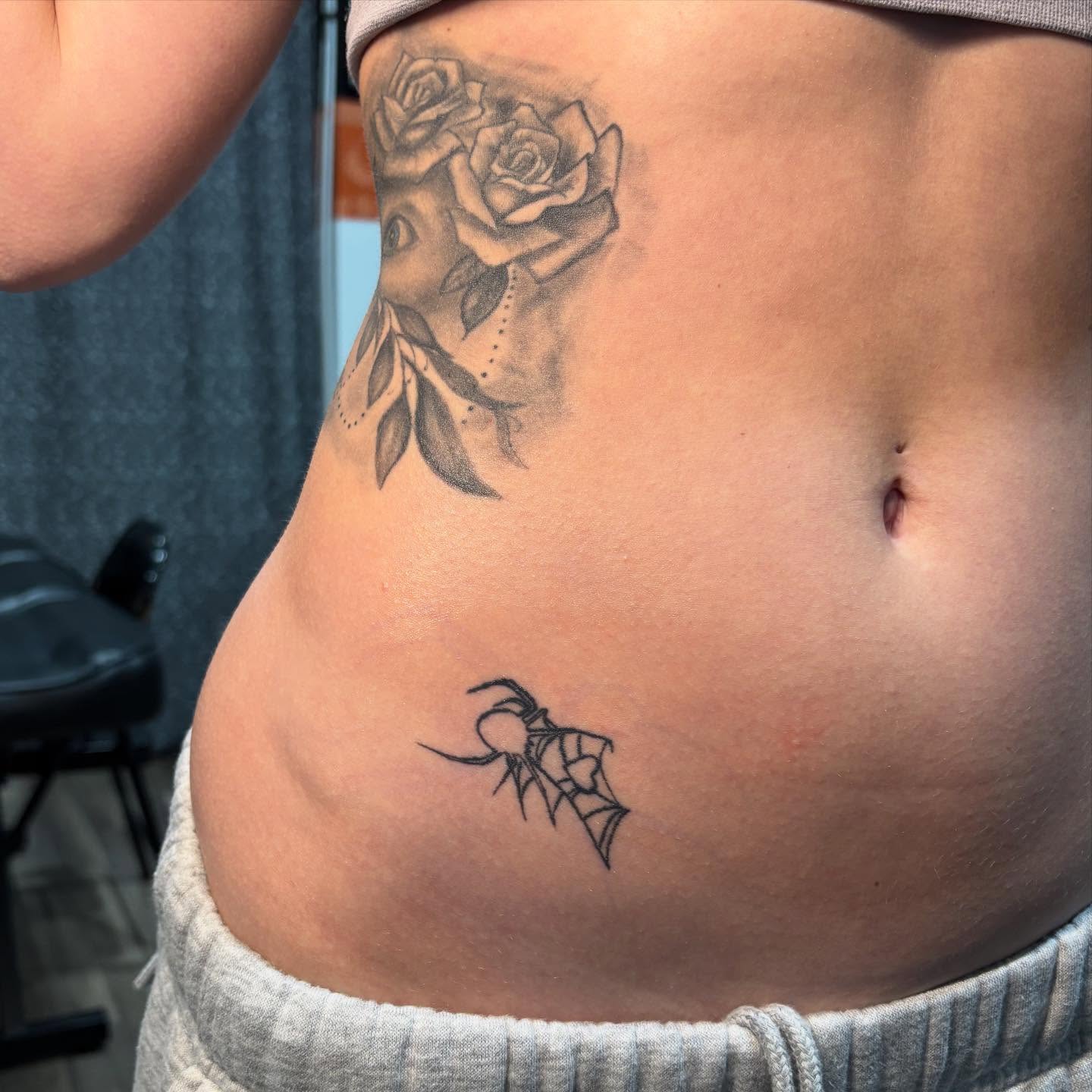 Roses and spider realism tattoo on the ribs by ꩜ 𖦹