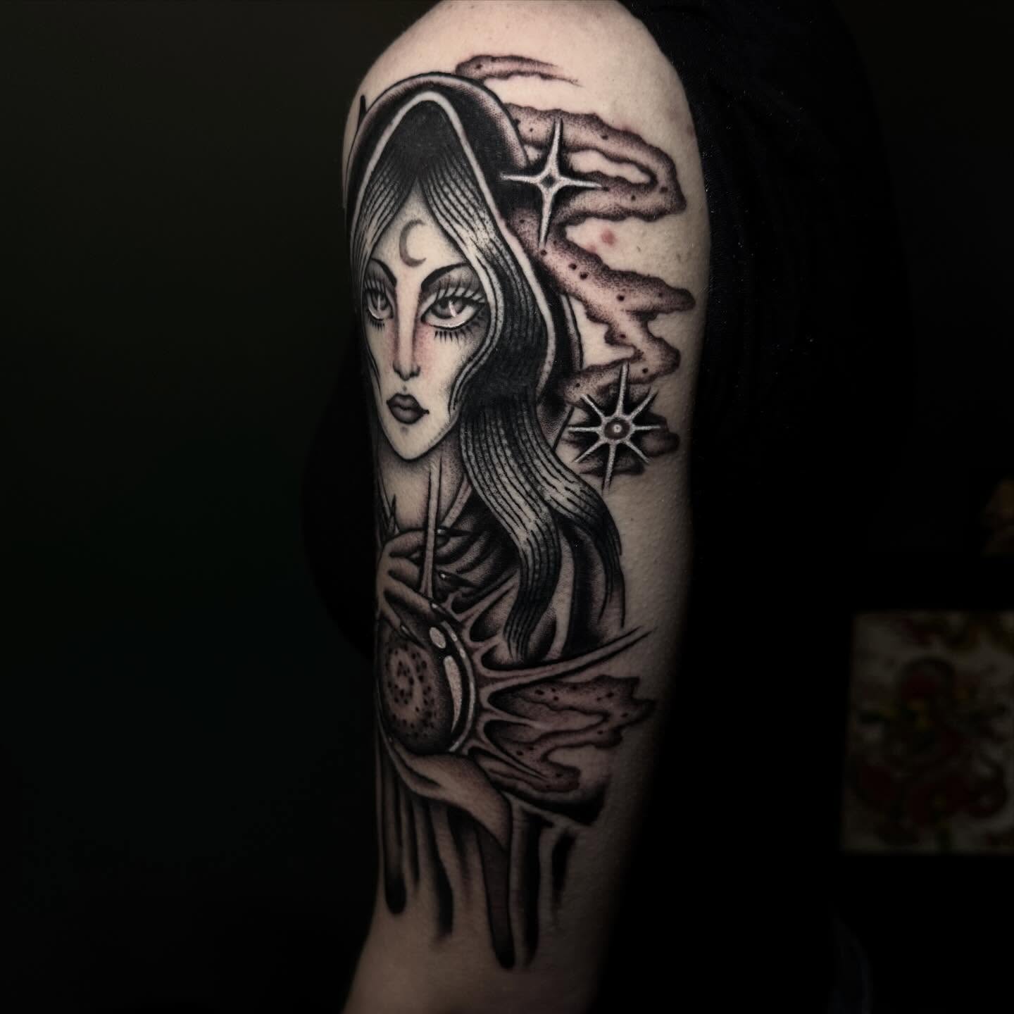 Woman with celestial motifs realism tattoo on the forearm by Julia Louise