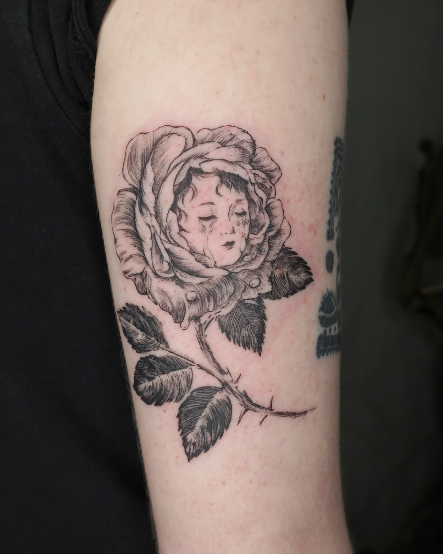 Rose with child realism tattoo on the forearm by Olivia
