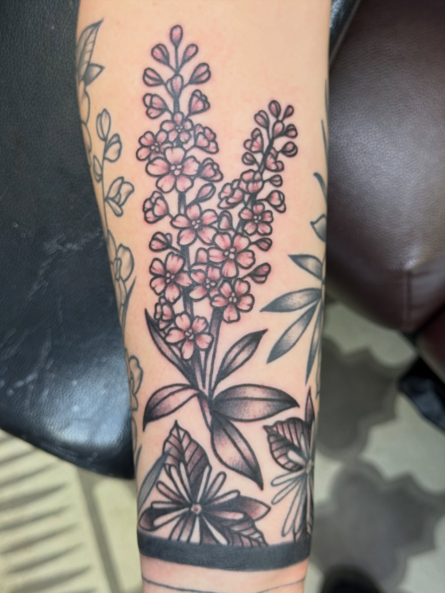 Flower arrangement black and grey tattoo on the forearm by Kelsey Louis, Iowa City, Iowa